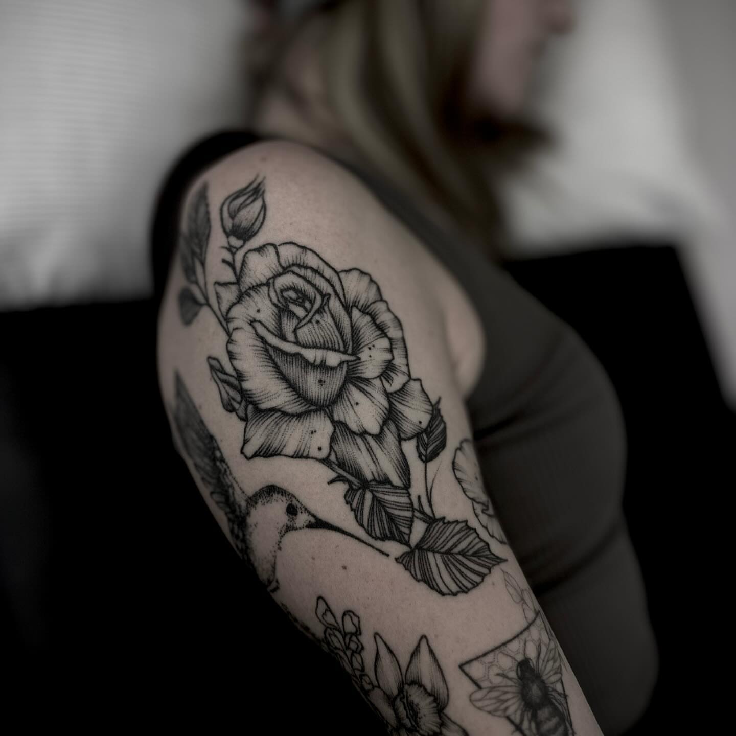 Rose and hummingbird realism tattoo on the upper arm by t a y l o r