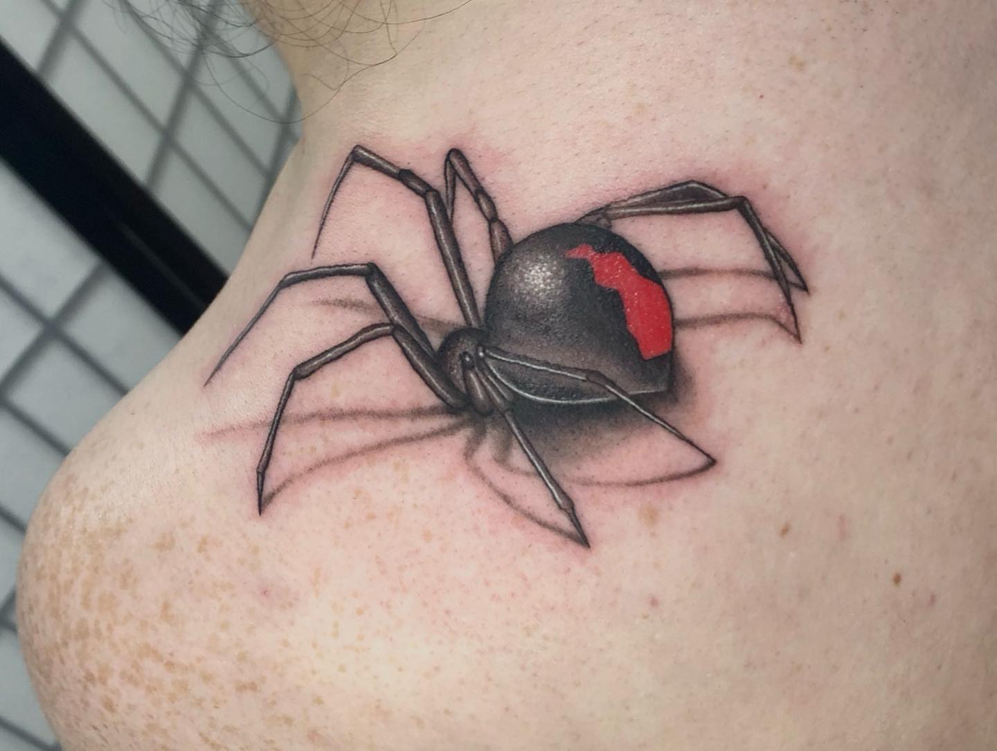 Black widow spider realism tattoo on the shoulder by Isabel Smith🦋🕷️