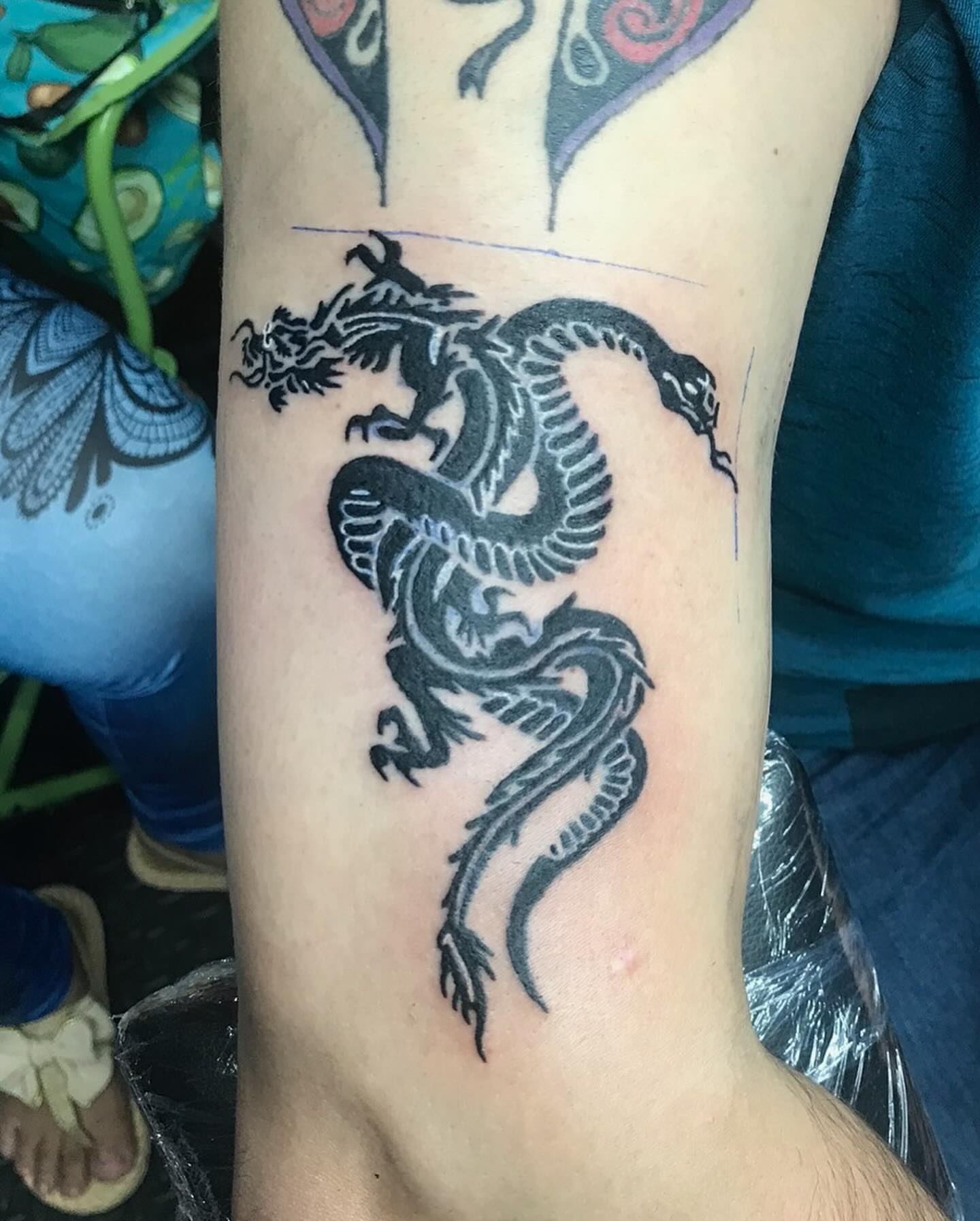 Dragon black and grey tattoo on the forearm by Ride The Needle Tattoos, New Britain, Connecticut