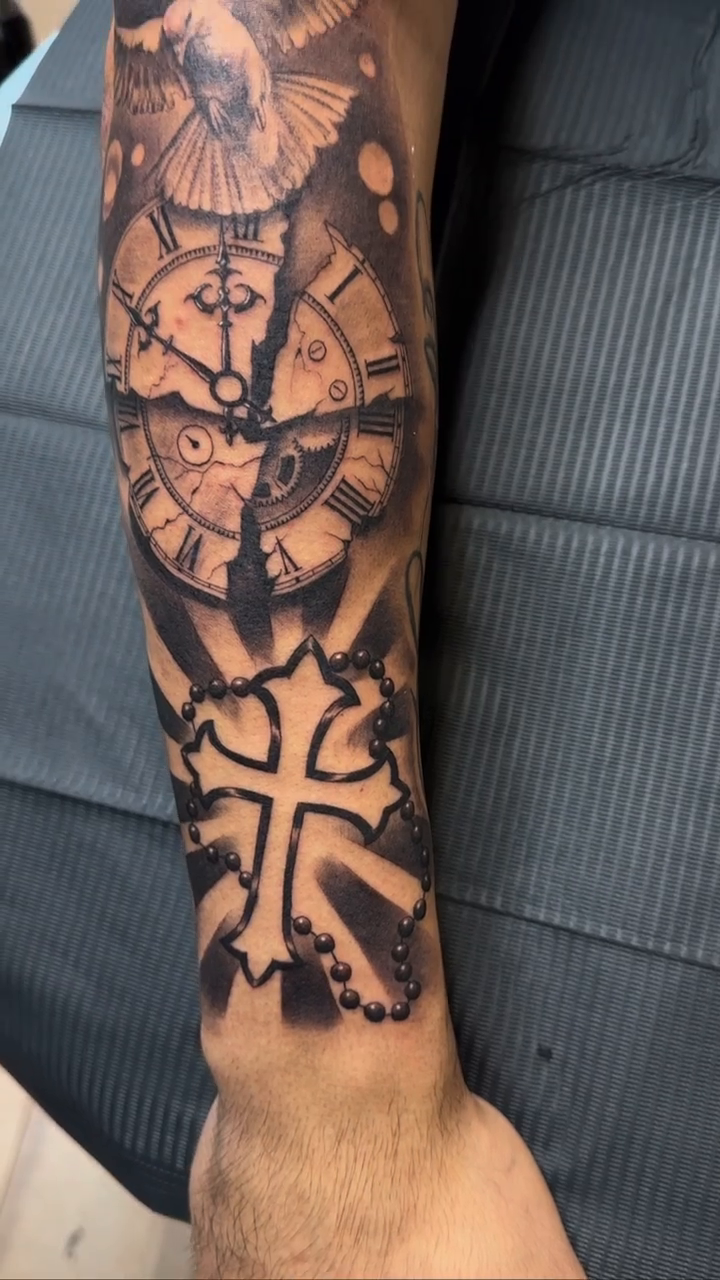 Clock, cross, and bird realism tattoo by Bruno Guerrero