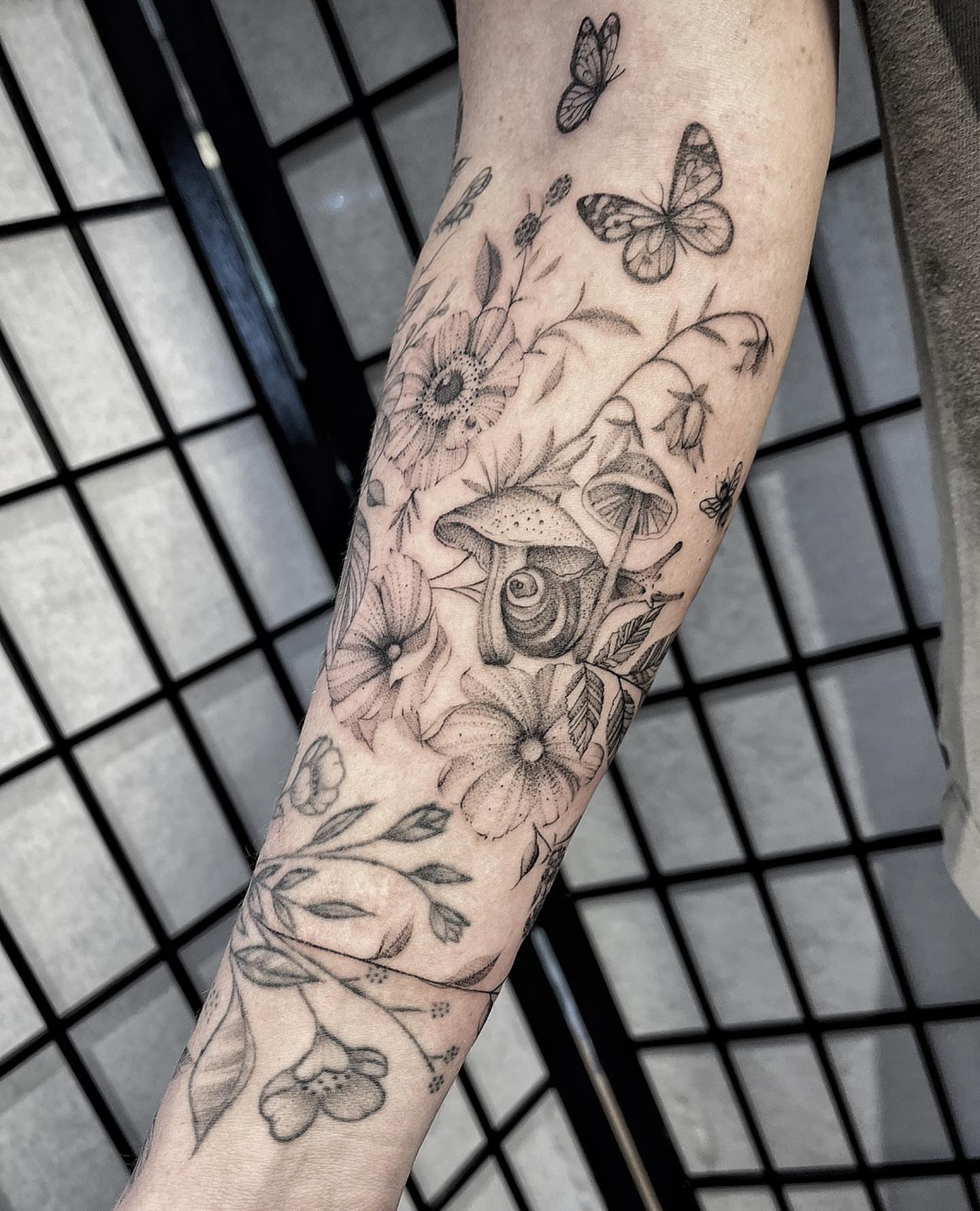 Flowers and butterflies realism tattoo on the forearm by Tattoo Yulia Kononenko