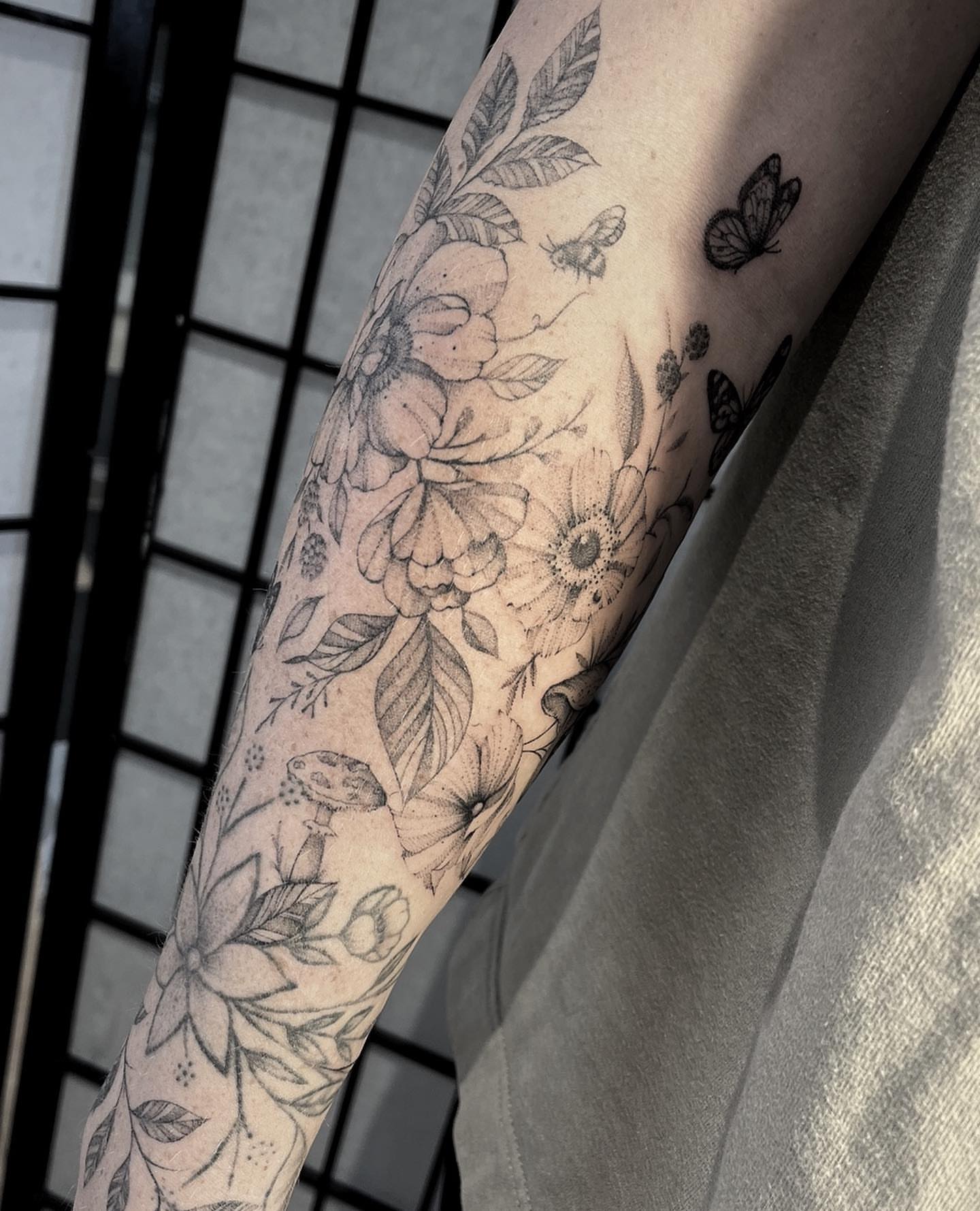 Floral bouquet dotwork tattoo on the forearm by Tattoo Yulia Kononenko