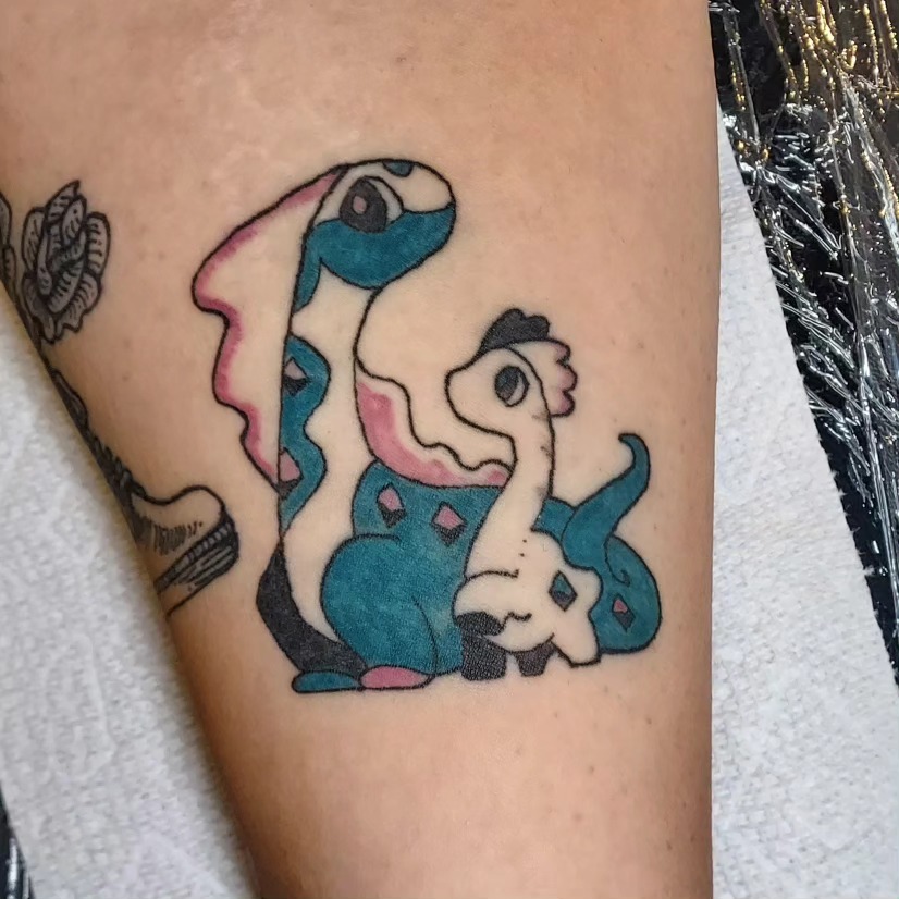 Dinosaur family dotwork tattoo on the forearm by Spike Cameron