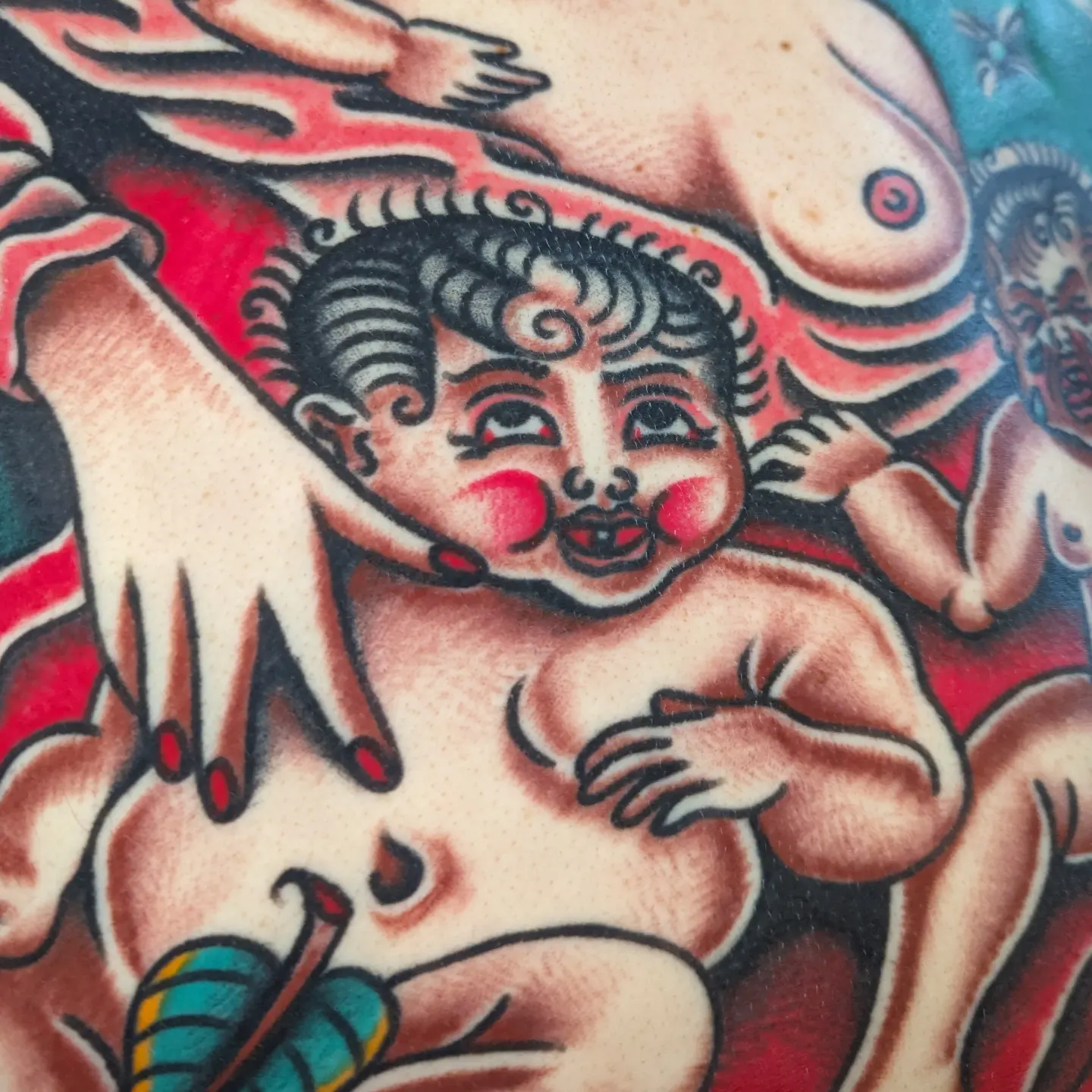 Baby with horns American traditional tattoo on the torso by Zack Mueller
