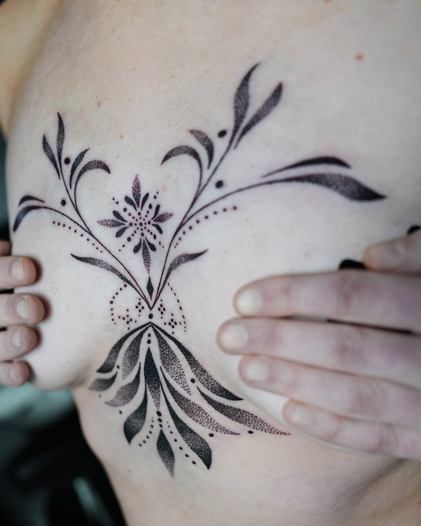 Floral design dotwork tattoo on the chest by ⓝⓐⓘⓡⓐⓓⓞⓣⓢ