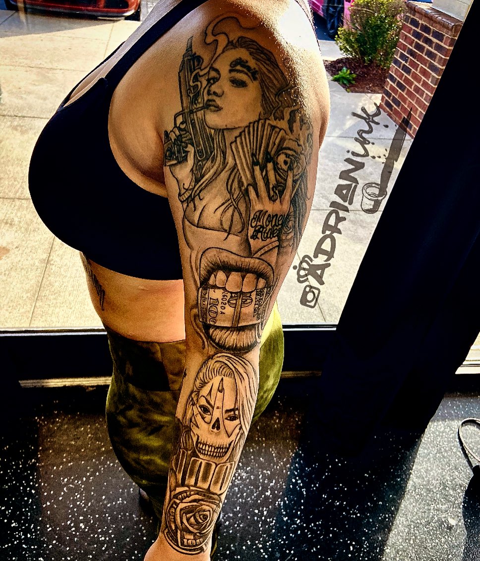 Woman with gun realism tattoo on the upper arm by Adrian Shan Carr
