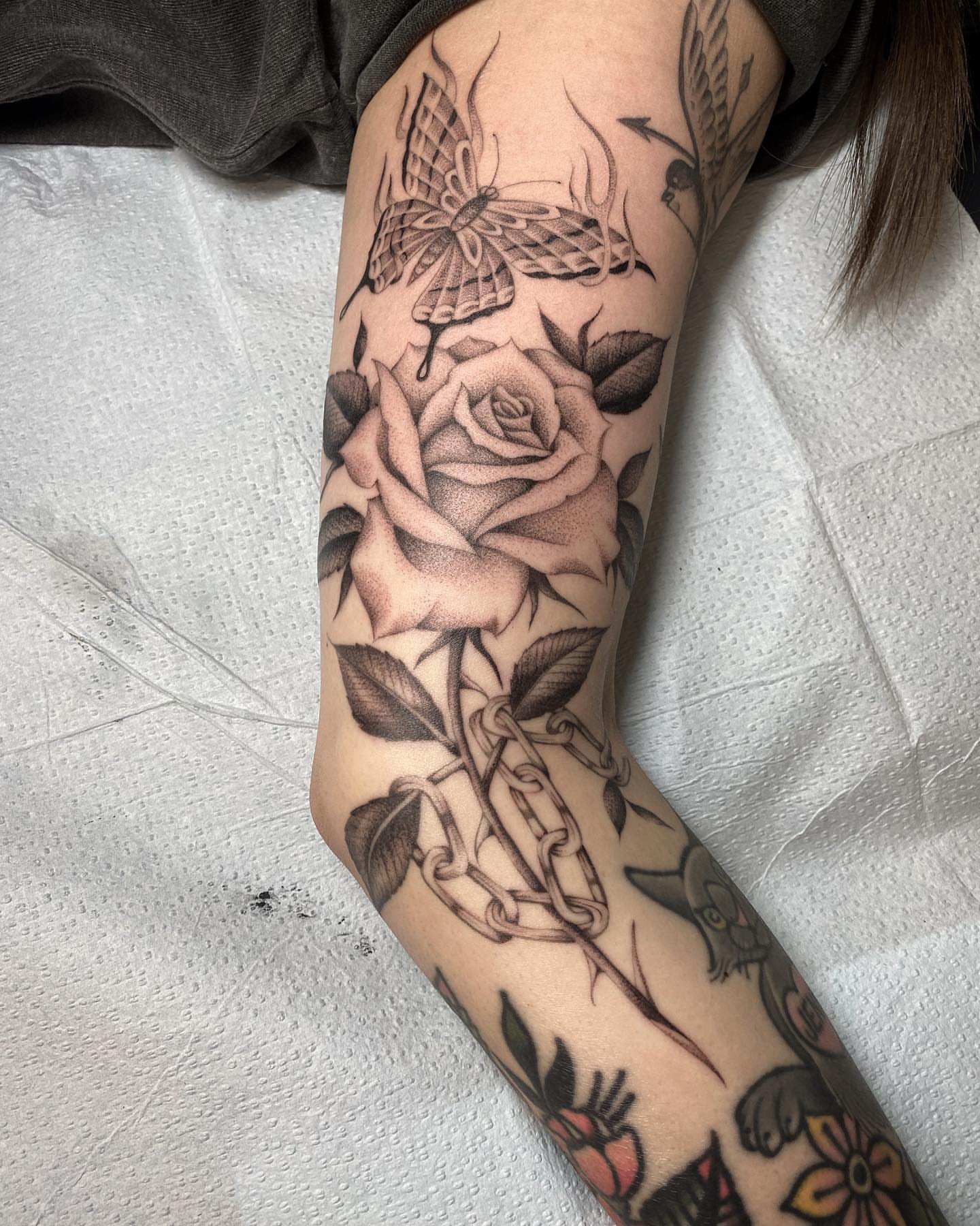 Rose and butterfly realism tattoo on the forearm by Alan Pham, San Jose, California