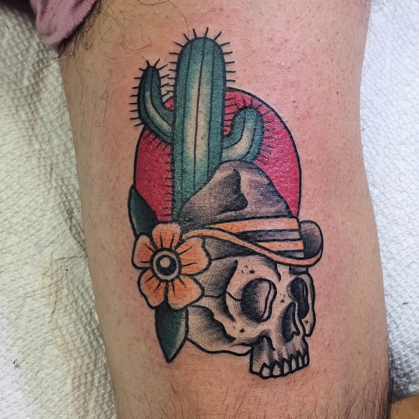 Skull with cactus and flower American traditional tattoo on the forearm by BZ Artistry