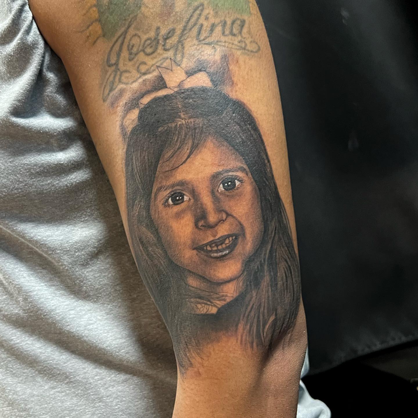 Child portrait realism tattoo on the forearm by JT Ink