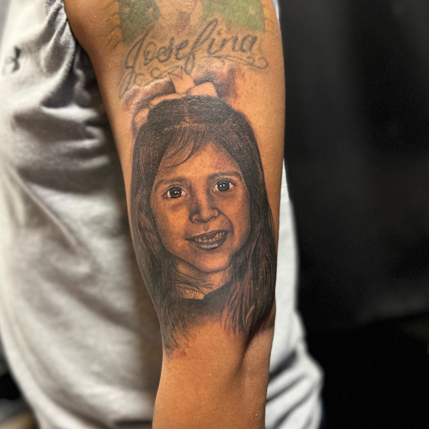Child portrait realism tattoo on the forearm by JT Ink