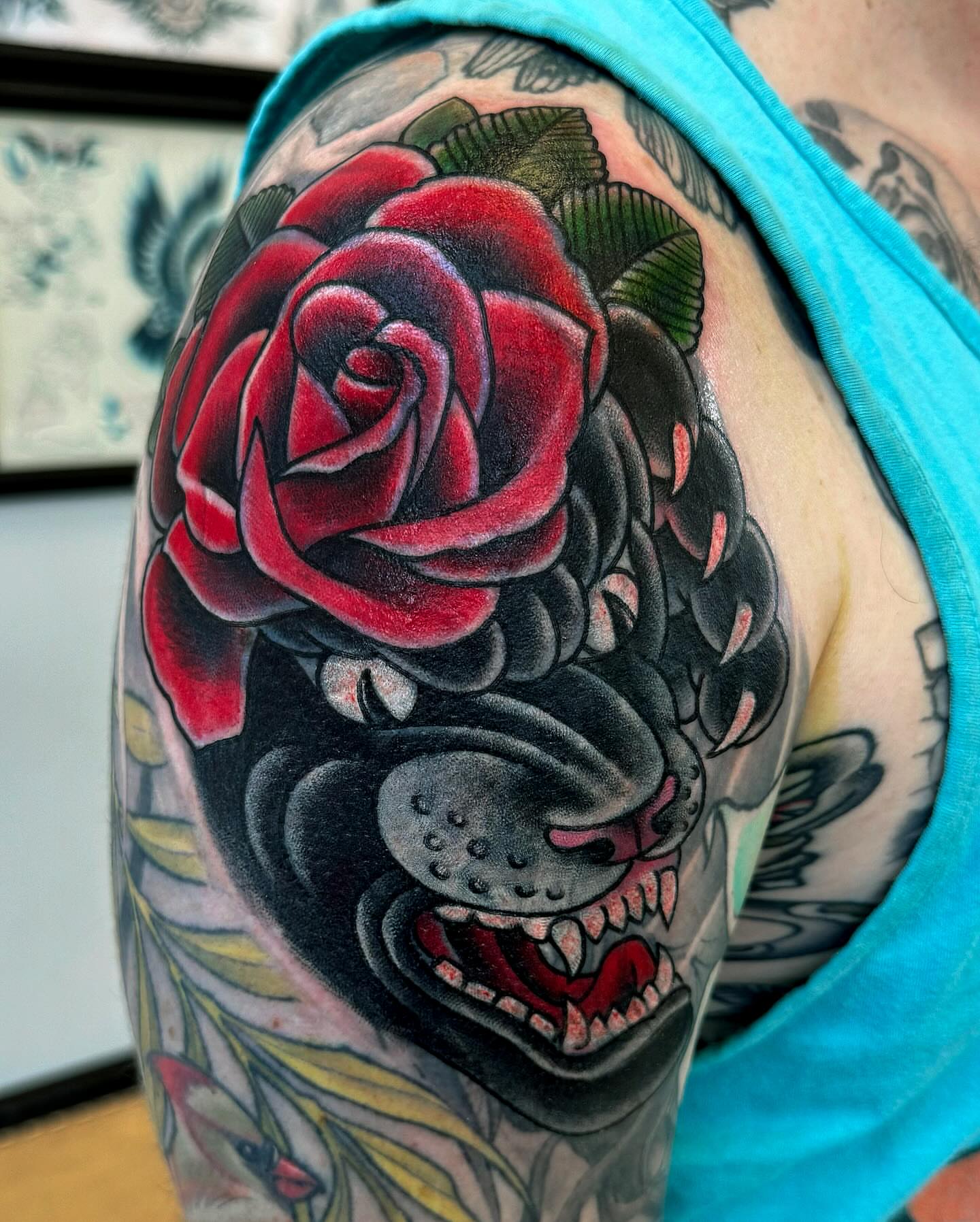 Rose and dog American traditional tattoo on the shoulder by Erick Lynch, Cambridge, Massachusetts