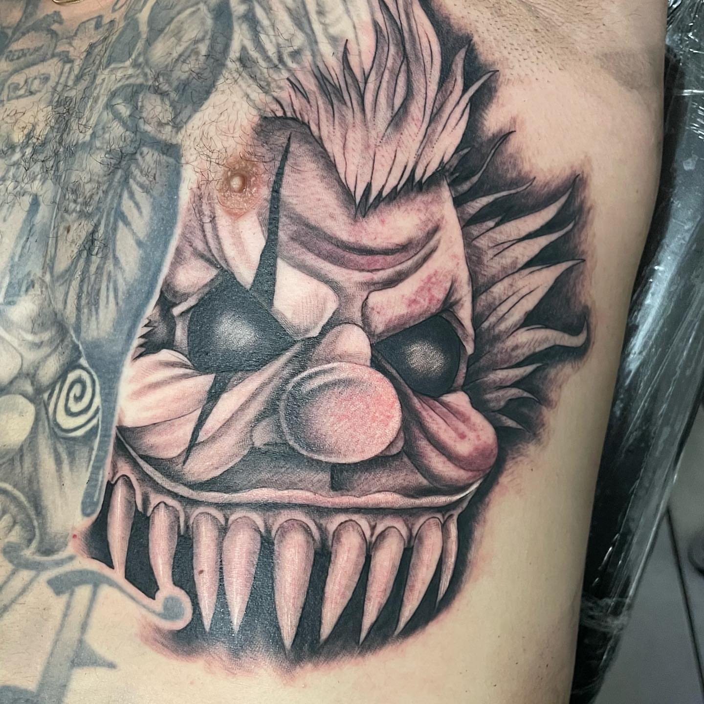 Clown black and grey tattoo on the thigh by payaso