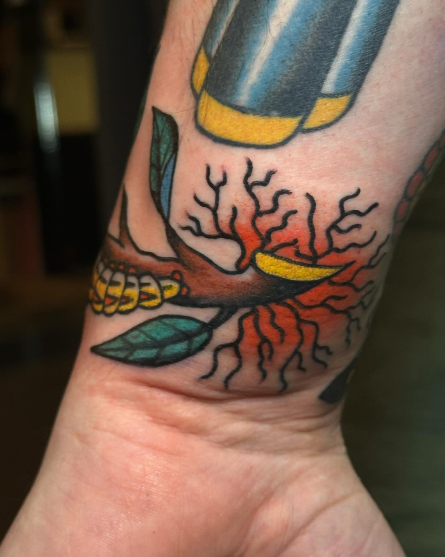 Bird and tree American traditional tattoo on the forearm by Britney Goodman