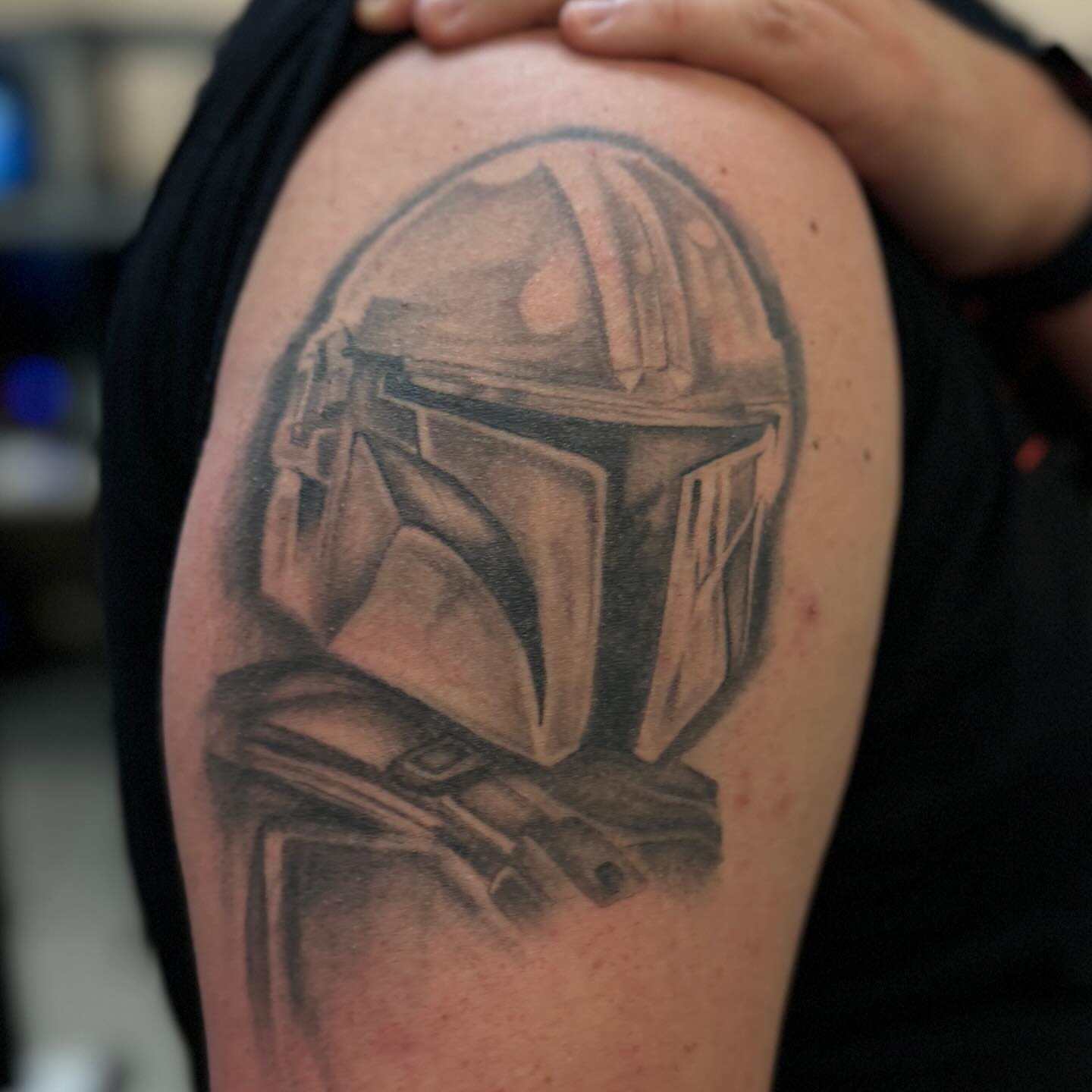 Mandalorian helmet realism tattoo on the shoulder by Steve