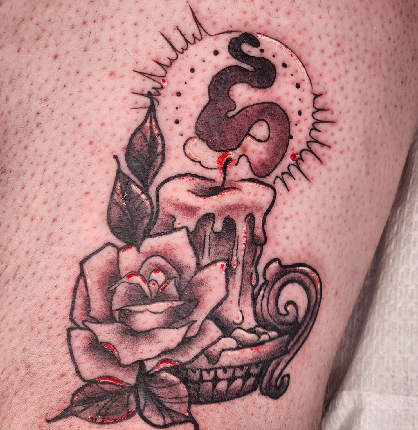 Candle and rose black and grey tattoo on the thigh by Audrey Luther