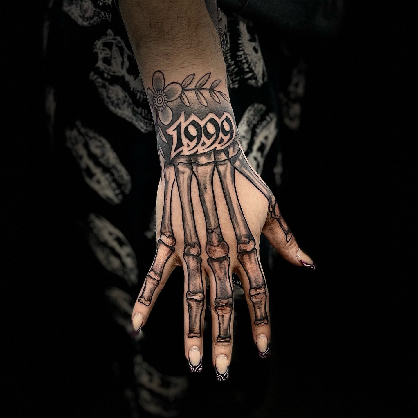Skeleton hand black and grey tattoo on the hand by Eduardo Gomez