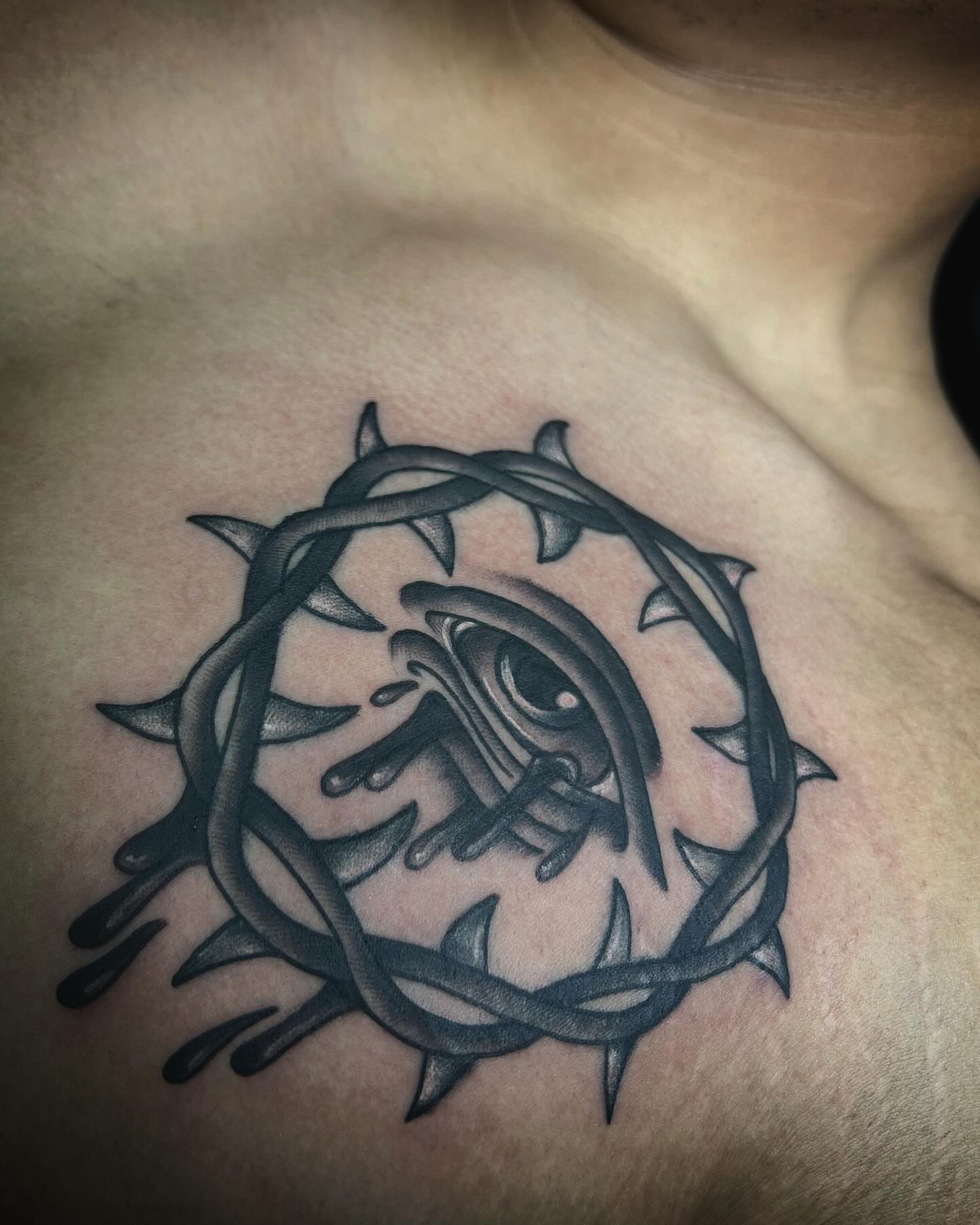Eye within crown of thorns dark realism tattoo on the chest by Samantha C, Bremerton, Washington