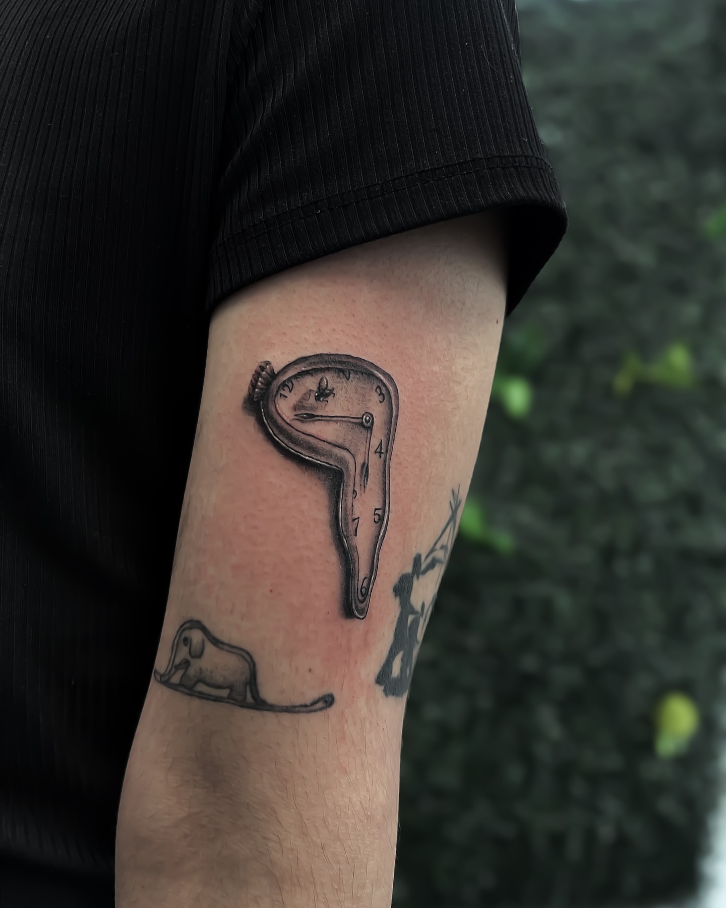 Melting clock realism tattoo on the forearm by Syd Cheyenne