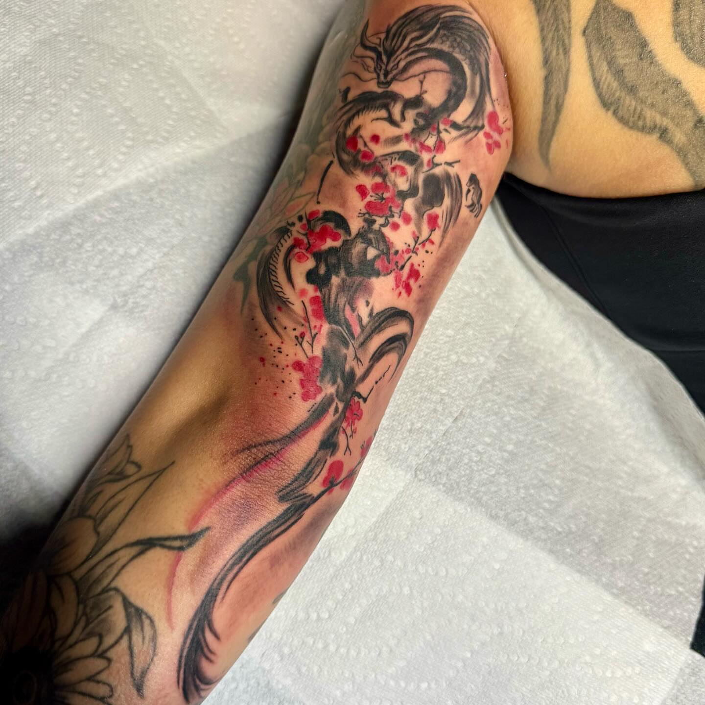 Dragon and cherry blossoms dotwork tattoo on the forearm by Anthony Pichardo 🦇