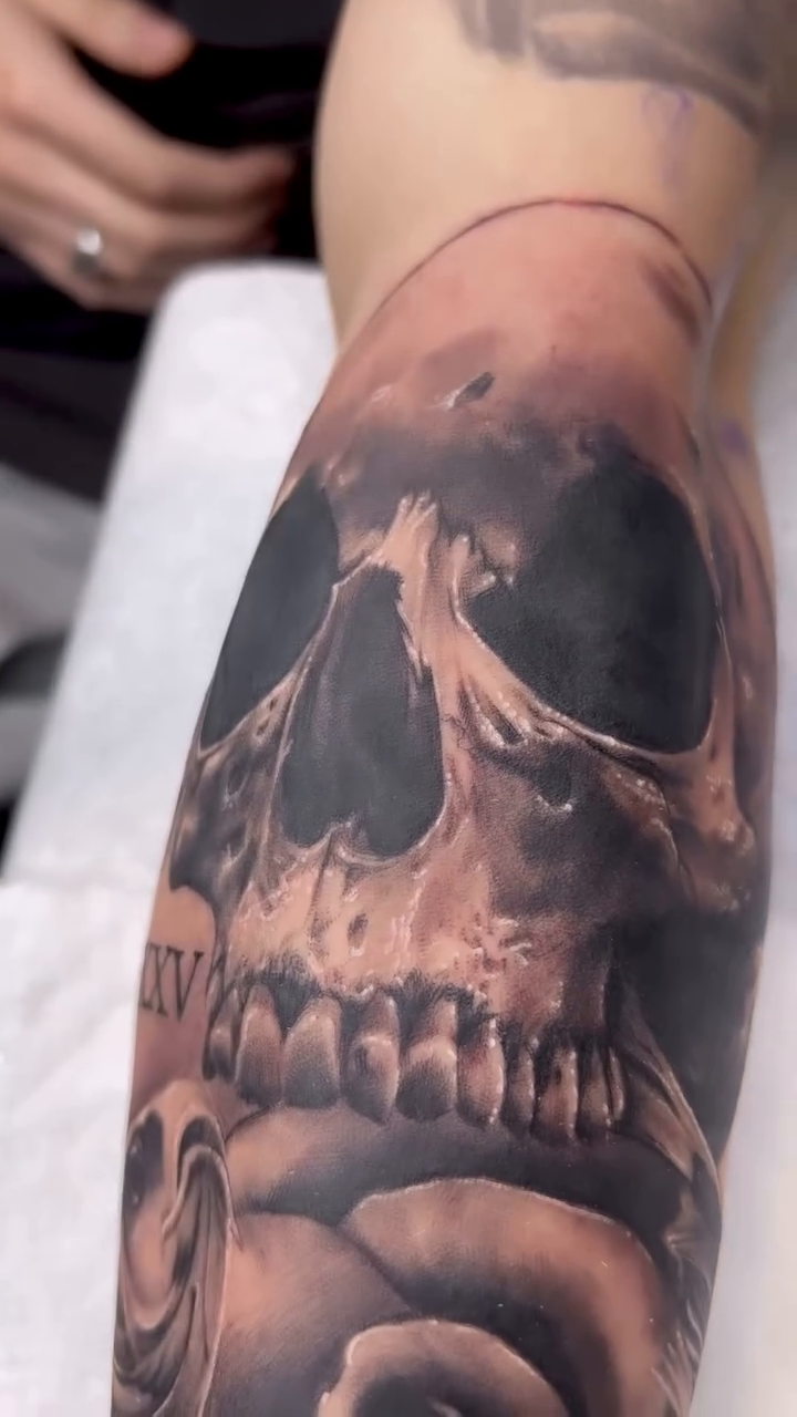 Skull and rose realism tattoo by Bailey Hancock