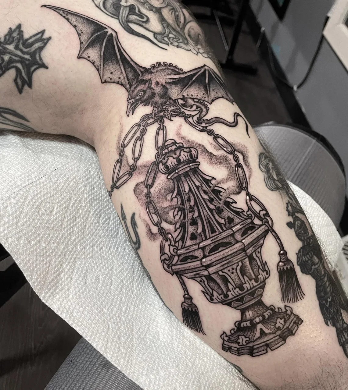 Censer and bat dark realism tattoo on the forearm by Lauren Vandevier