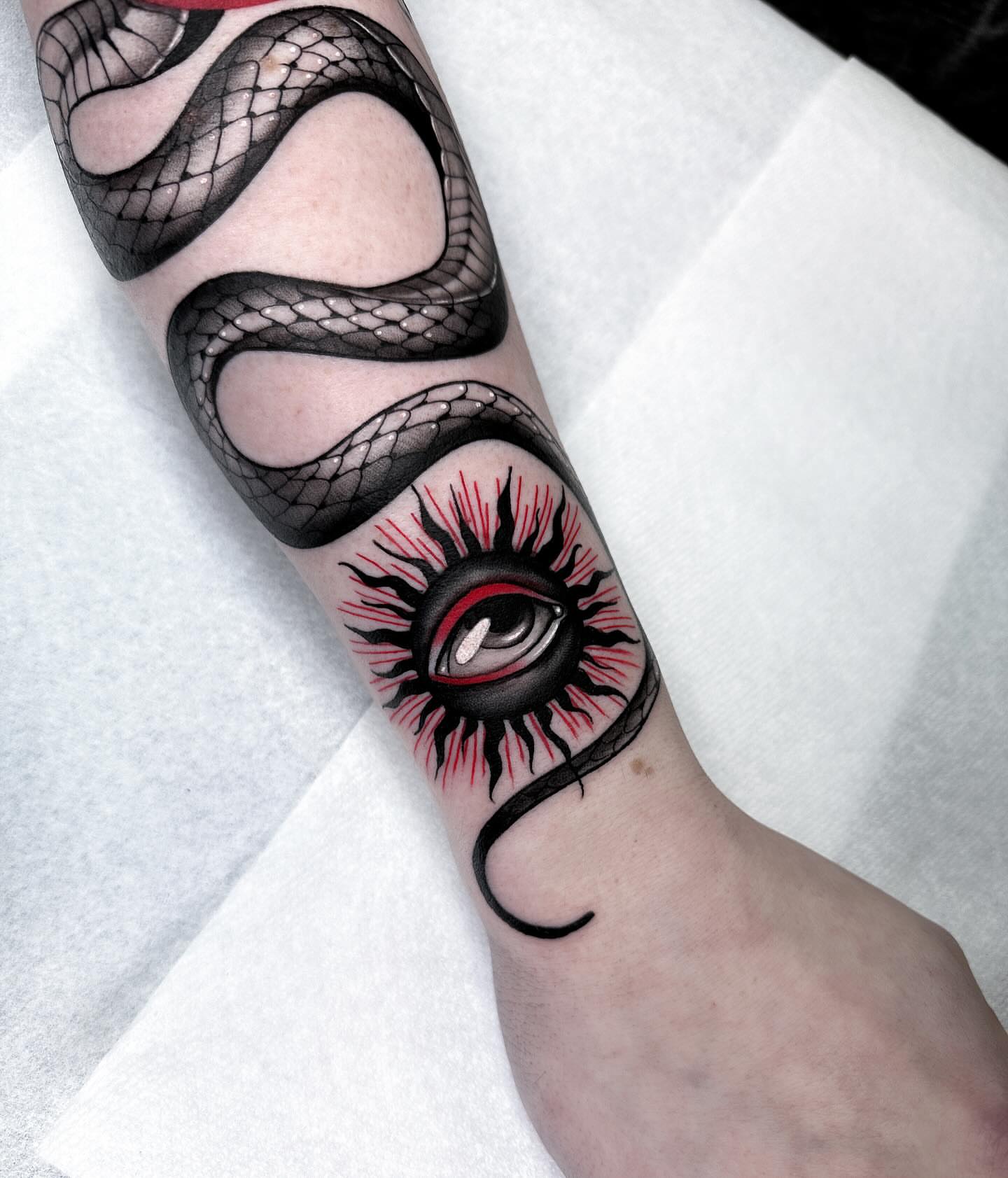 Snake and eye realism tattoo on the forearm by Tattoos in Federal Way, WA🖤