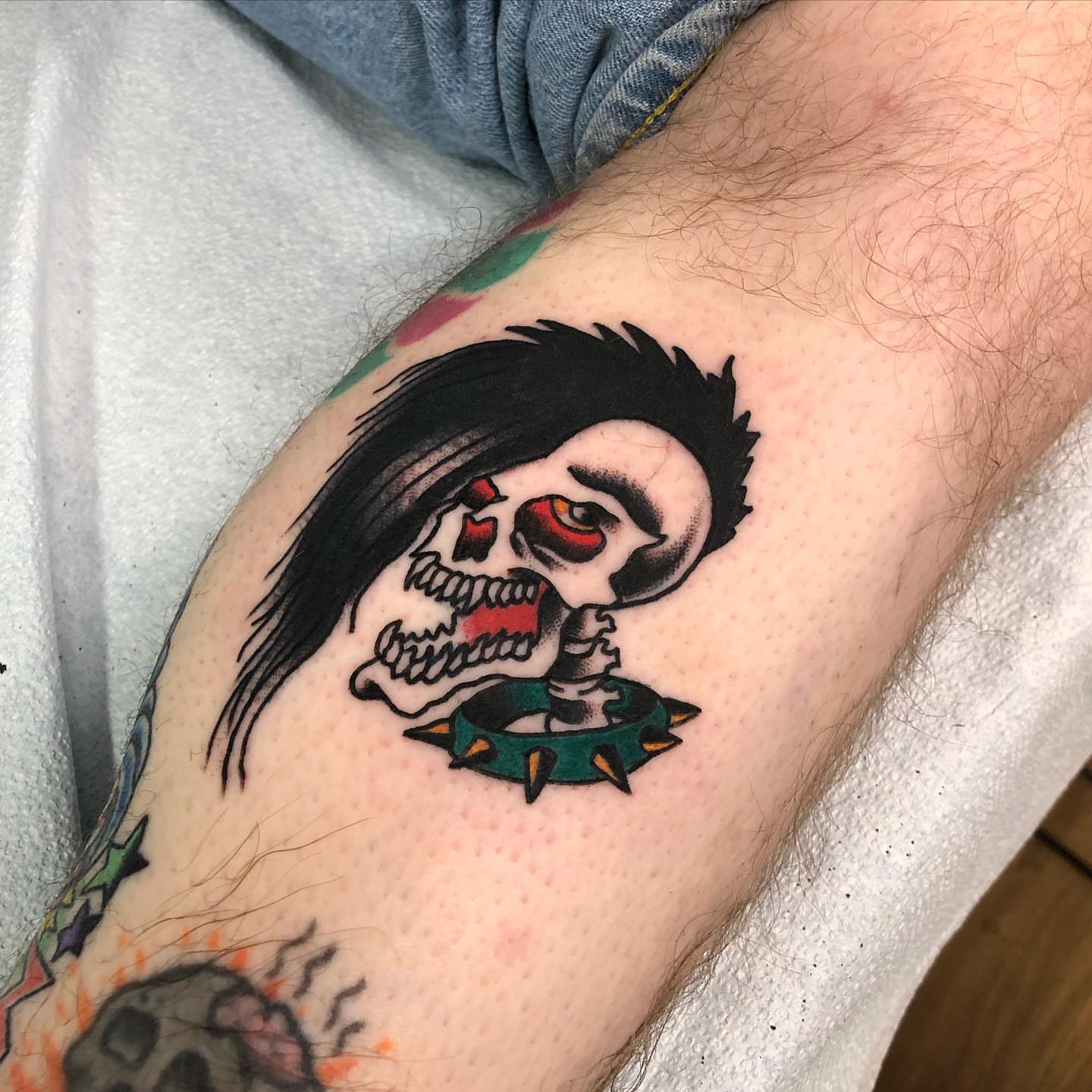 Skull with long hair American traditional tattoo on the forearm by Brent G