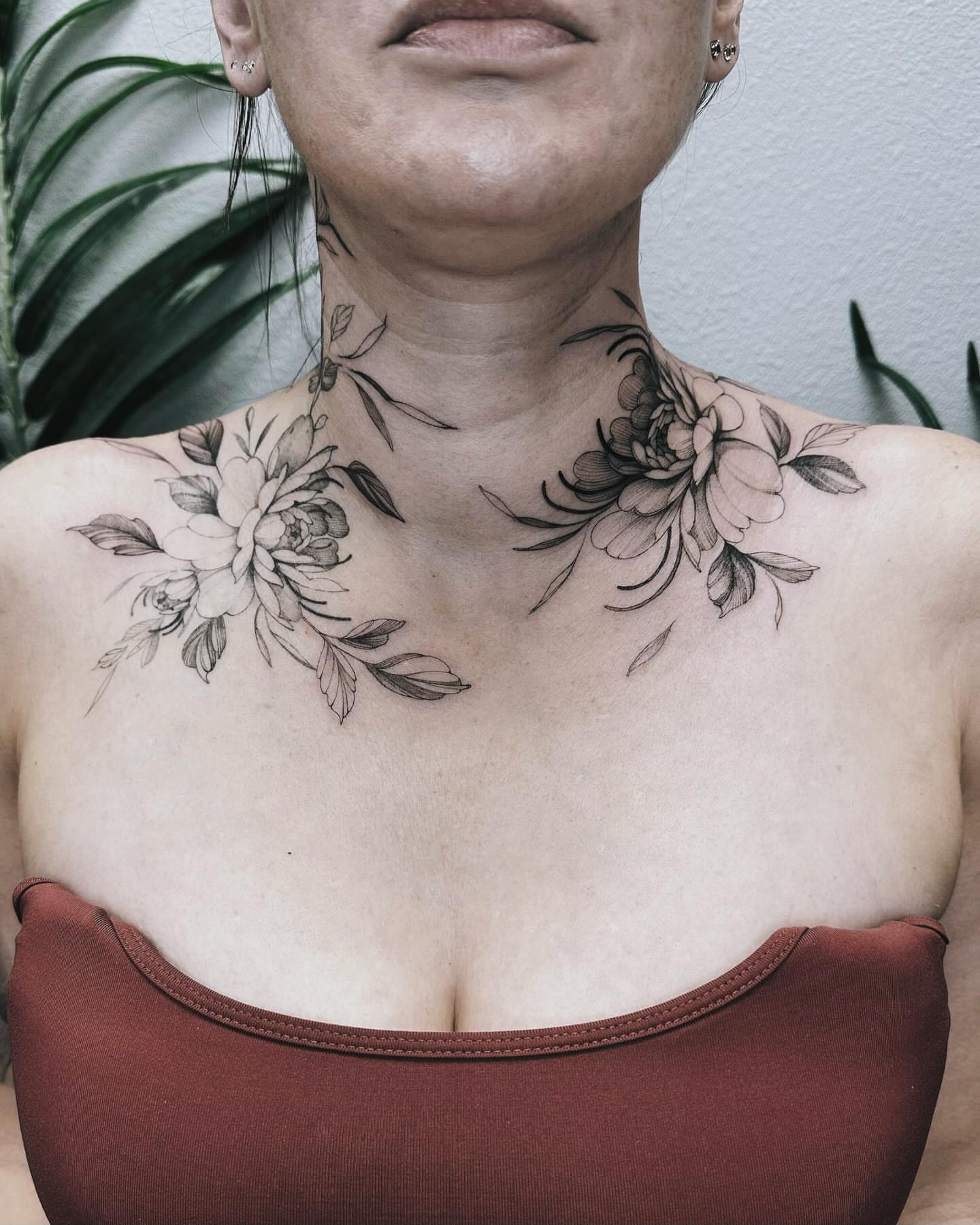 Floral black and grey tattoo on the neck by Angel
