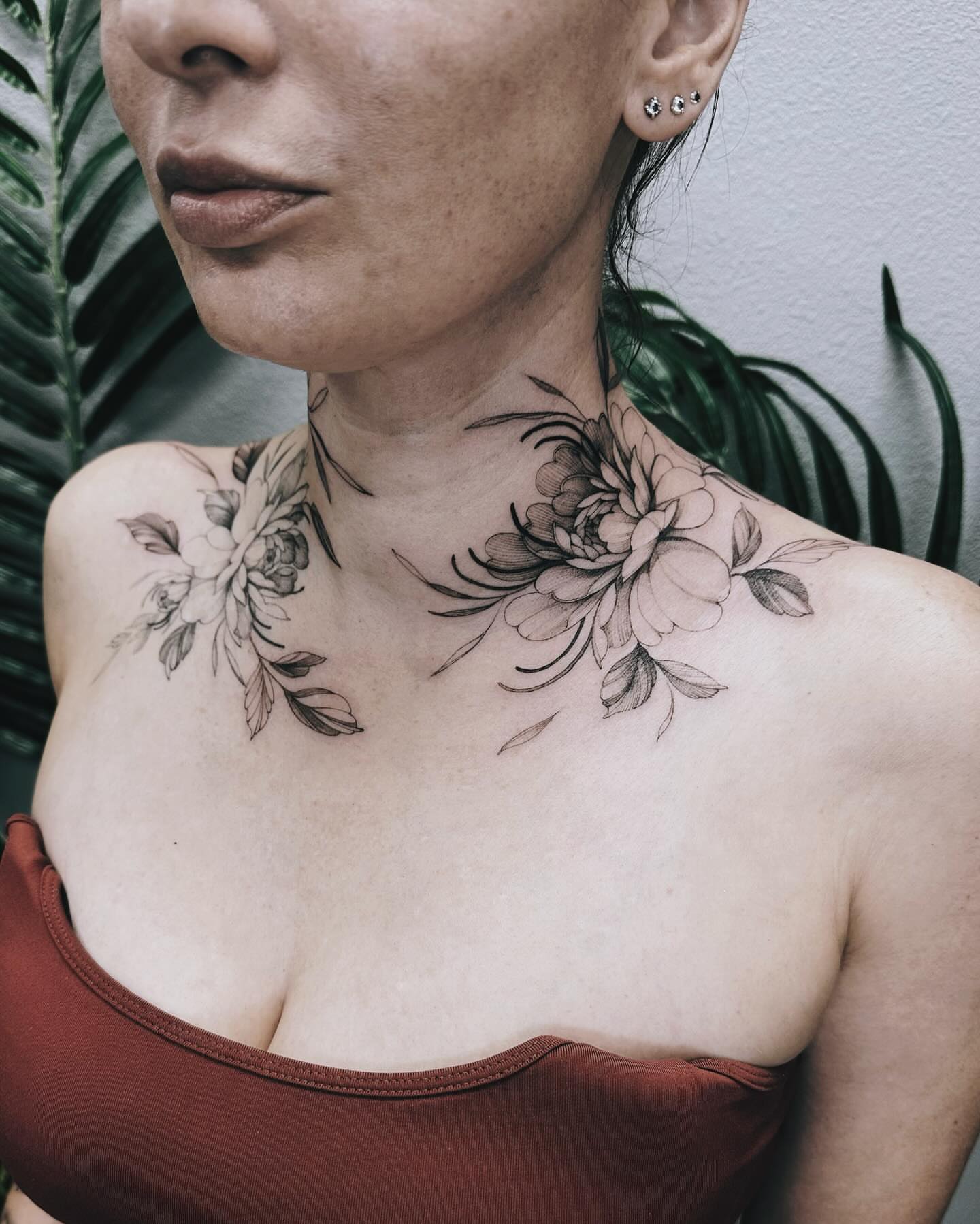 Floral black and grey tattoo on the chest by Angel