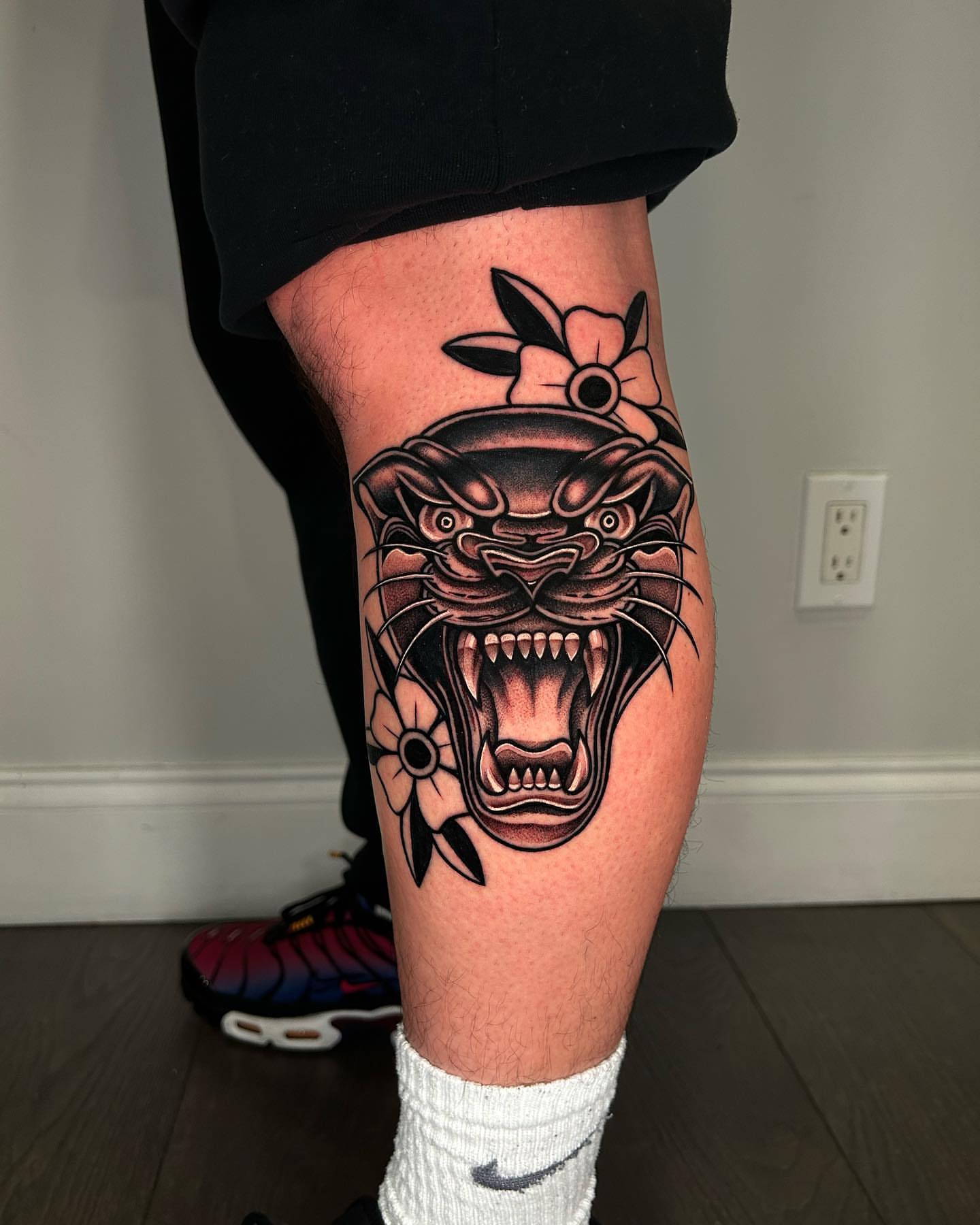 Roaring panther American traditional tattoo on the thigh by Lexi Kniskern