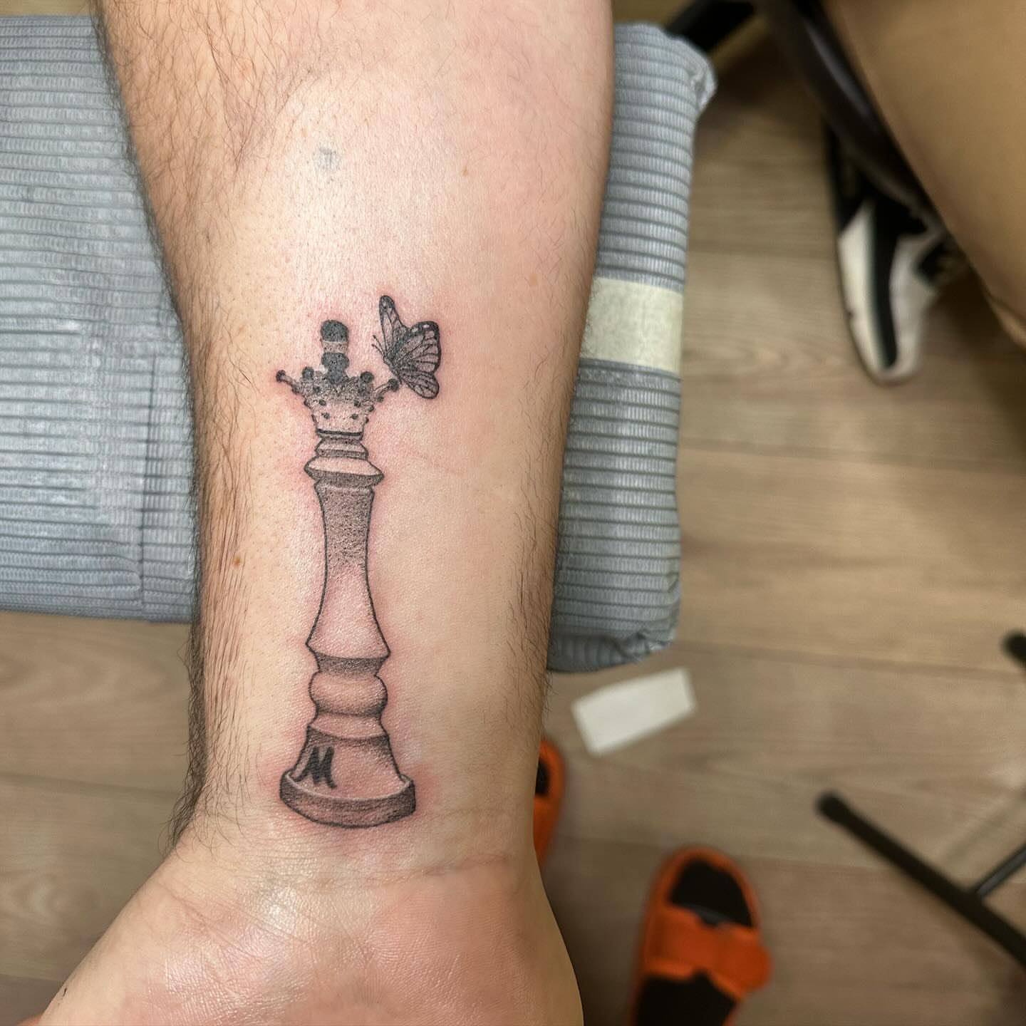 Chess king black and grey tattoo on the forearm by Roxanne Ochoa