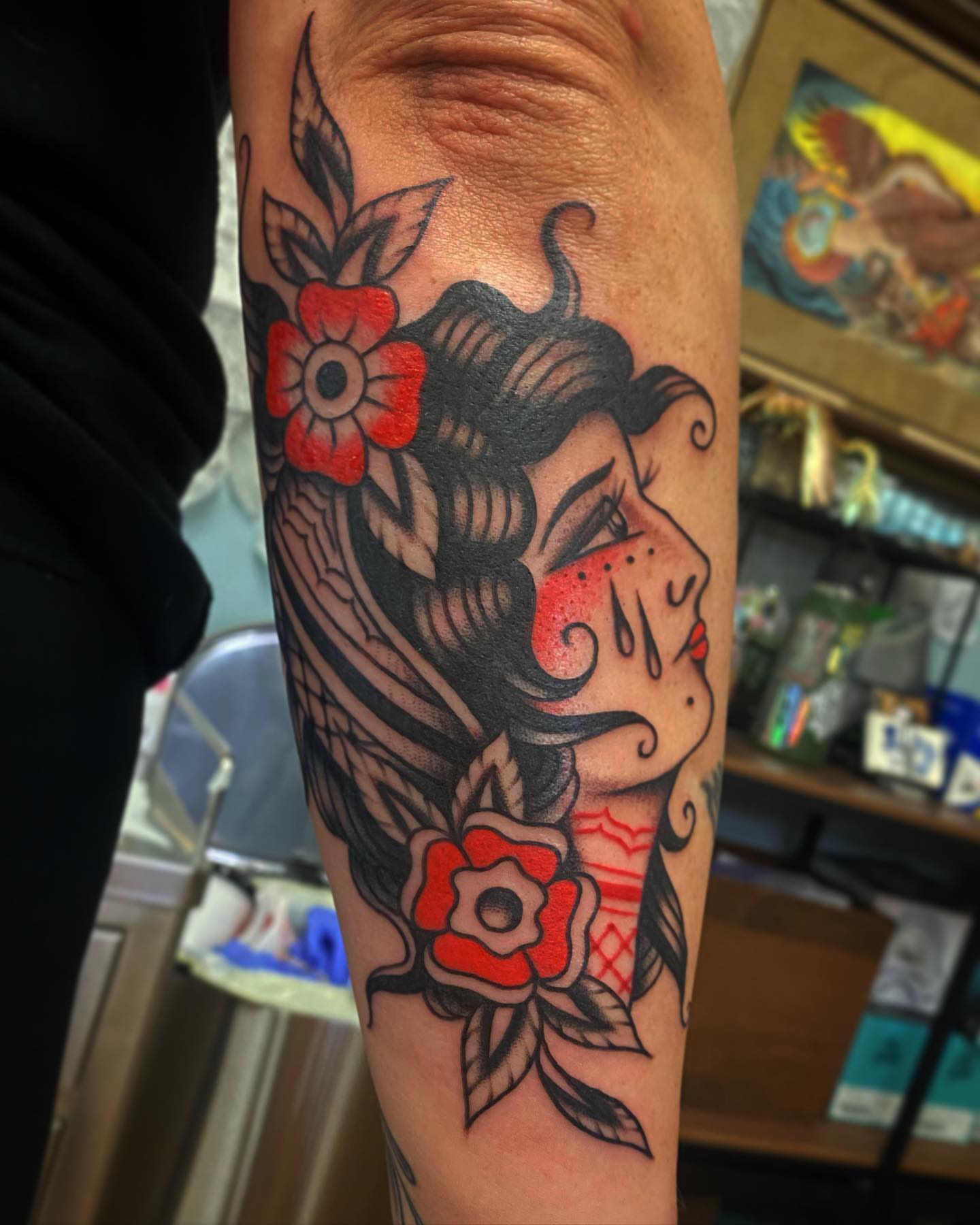 Woman with flowers American traditional tattoo on the forearm by Alan Pham, San Jose, California