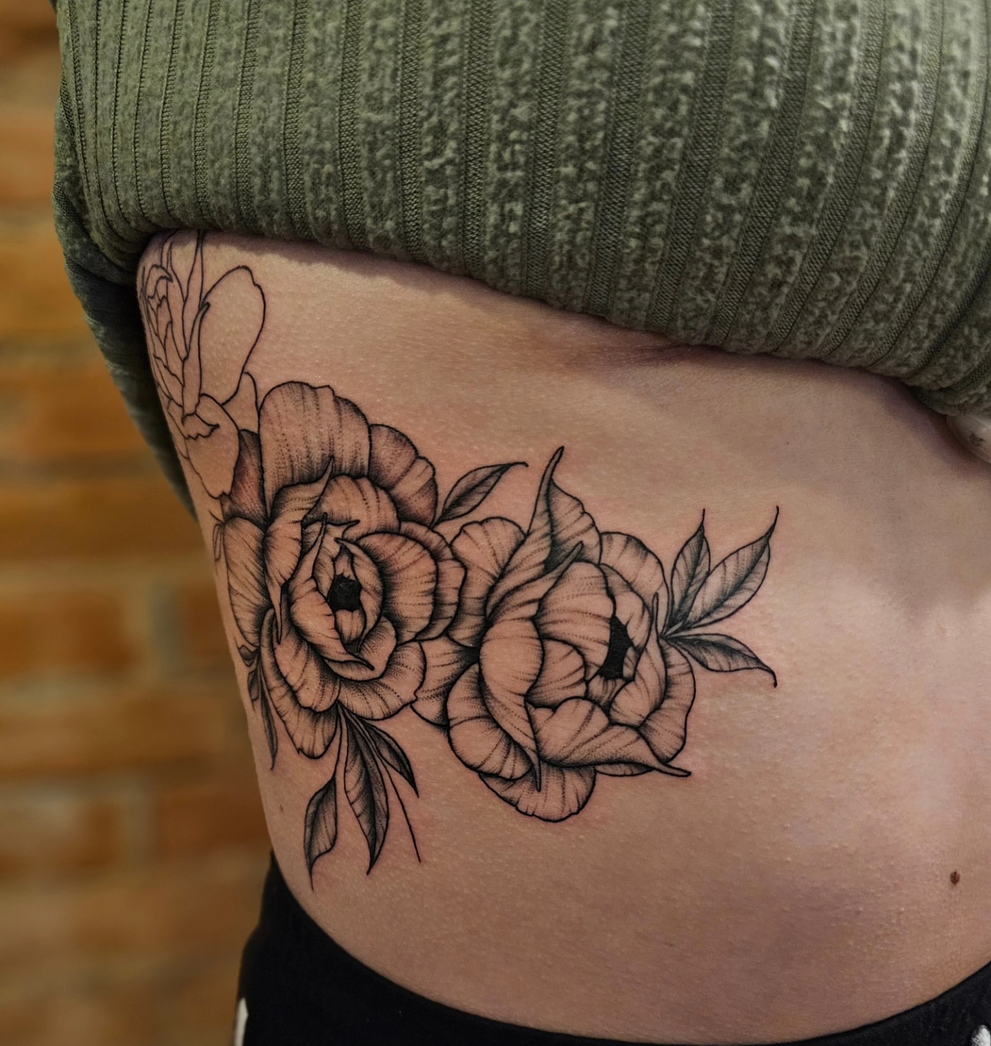 Floral bouquet black and grey tattoo on the ribs by Madelynne