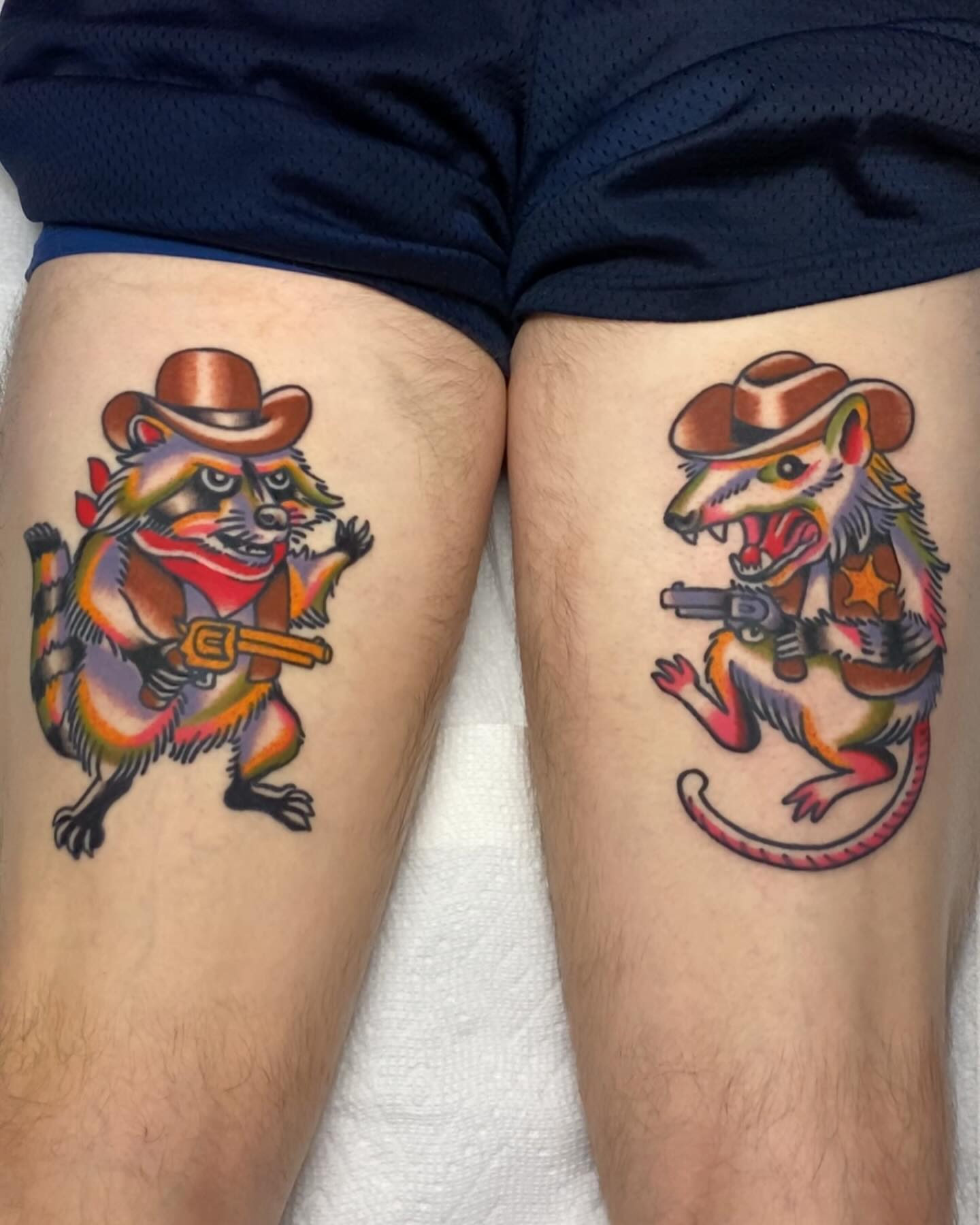 Raccoon and opossum American traditional tattoo on the thigh by Mitch Hoggard