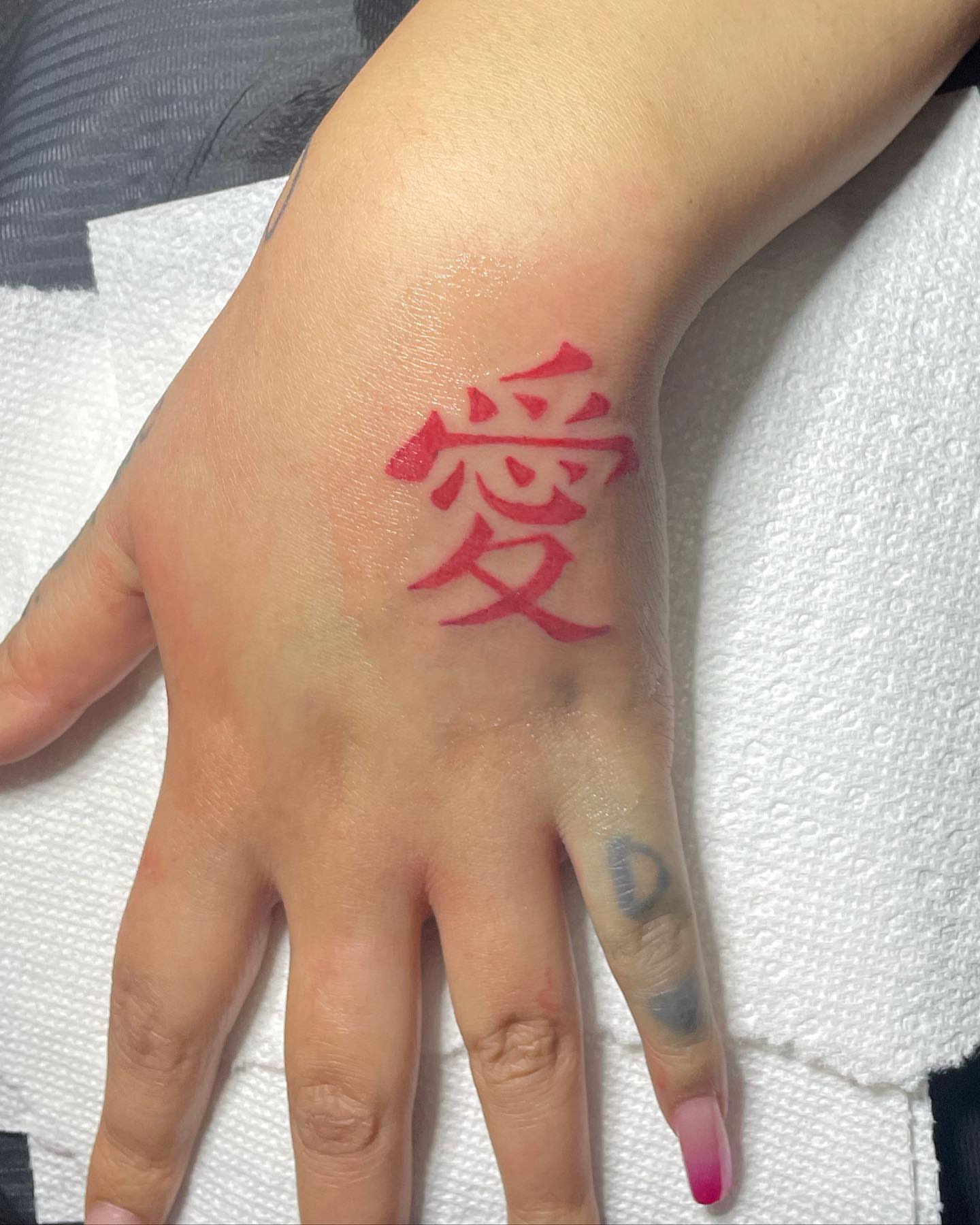 Kanji character lettering script tattoo on the hand by ART