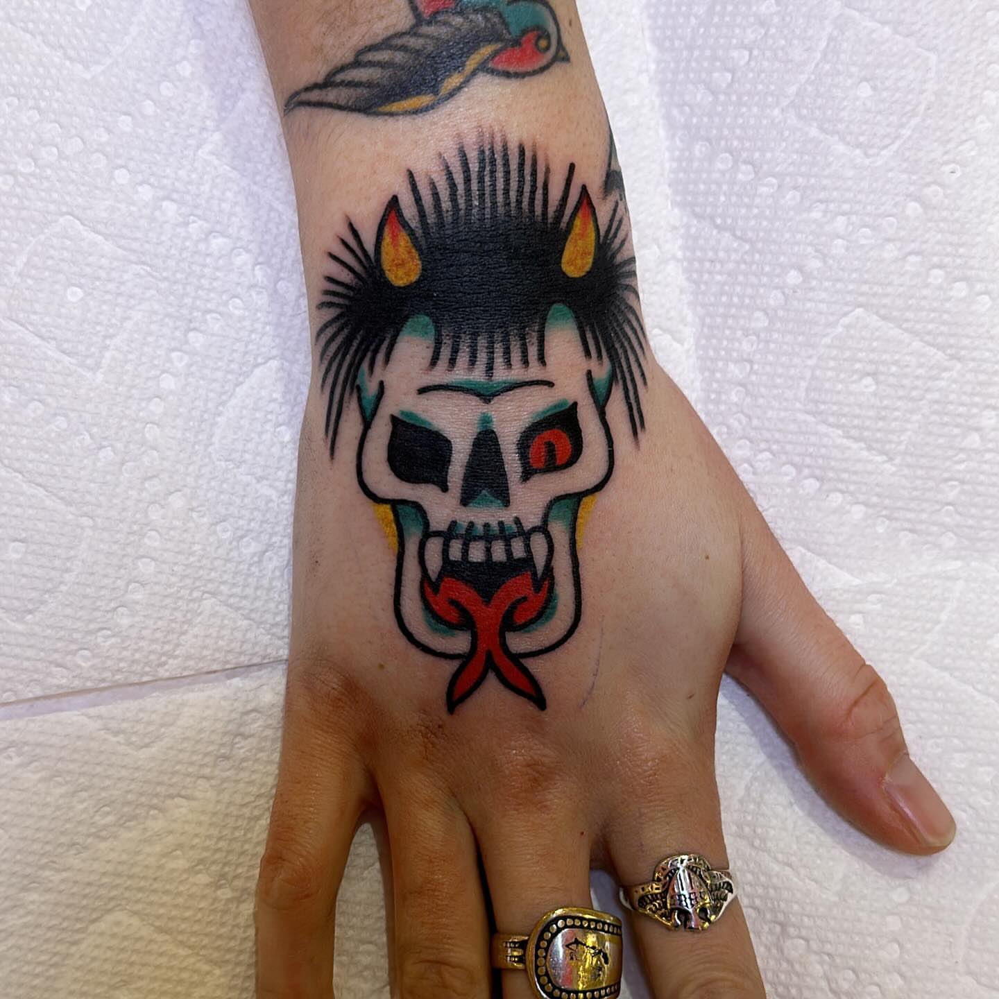 Punk skull American traditional tattoo on the hand by Isaac Brethauer