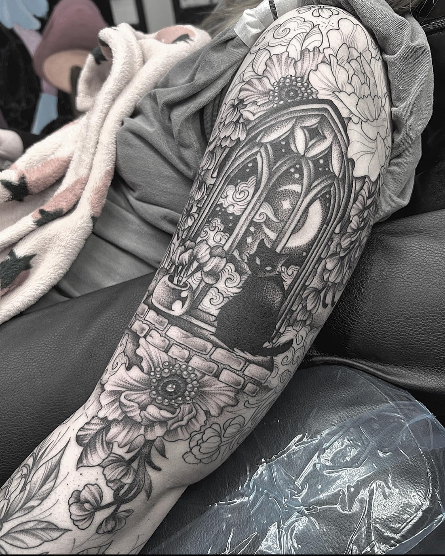 Cat and floral archway realism tattoo on the forearm by Anna Nicole Thomas