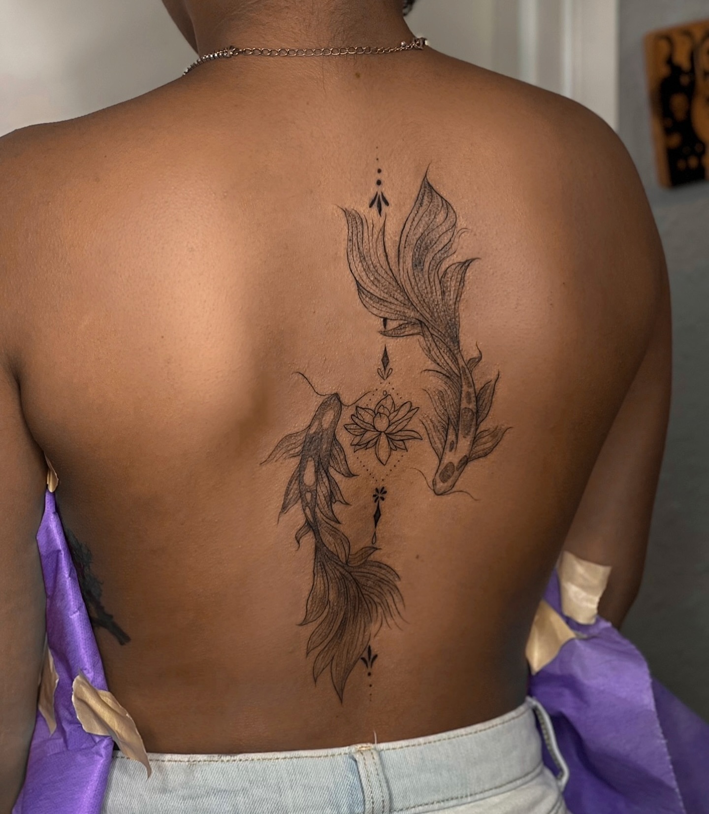 Koi fish and lotus dotwork tattoo on the back by Dee, San Diego, California
