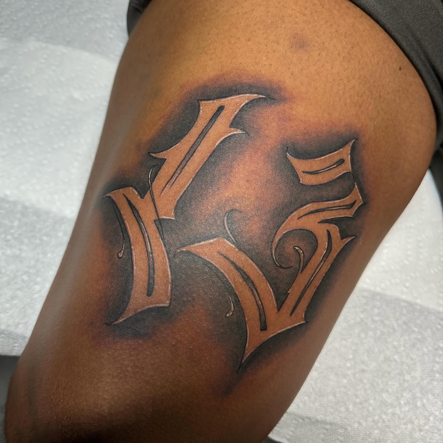Lettering black and grey tattoo on the thigh by Anthony Pichardo 🦇
