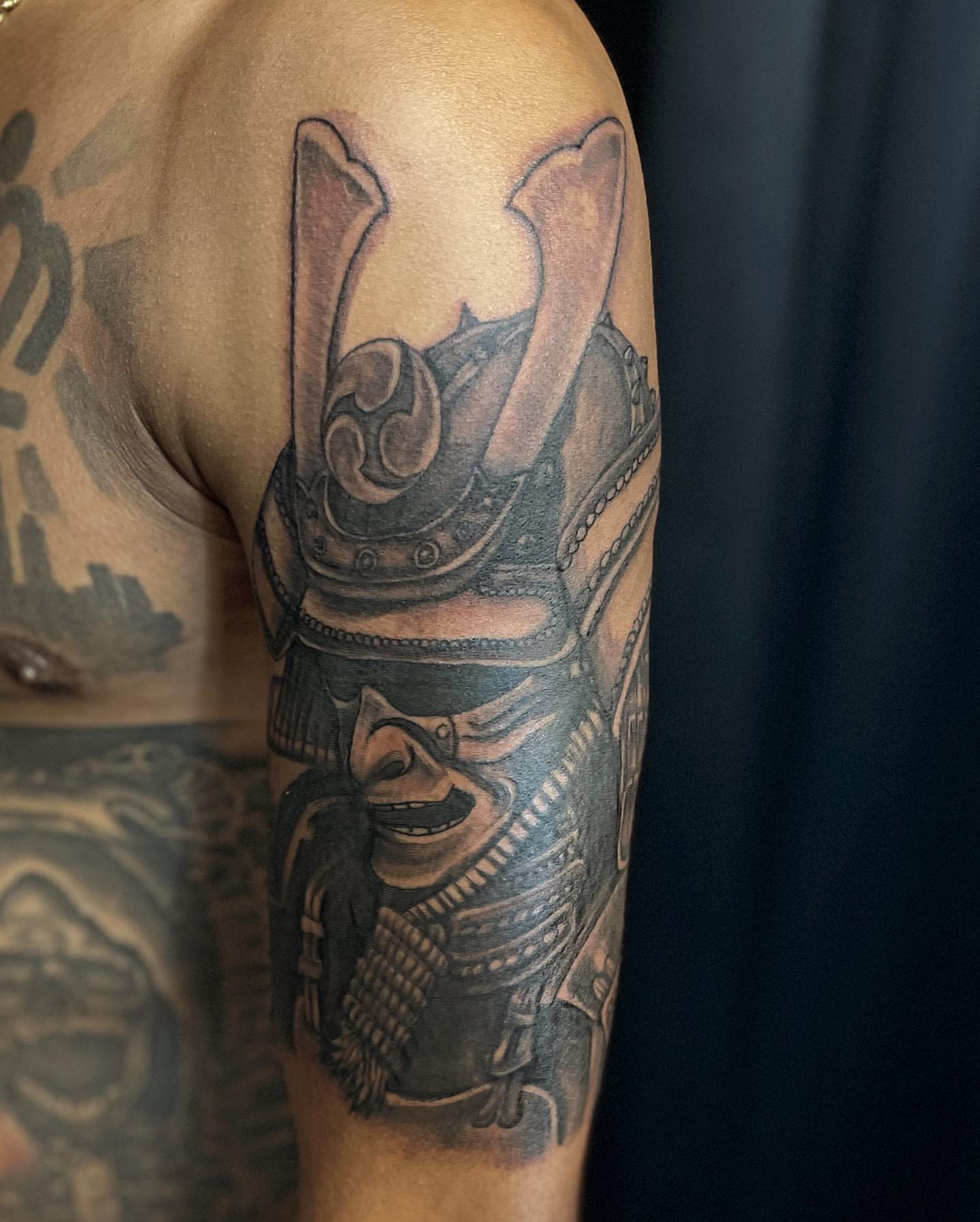 Samurai helmet realism tattoo on the shoulder by Adrian Shan Carr