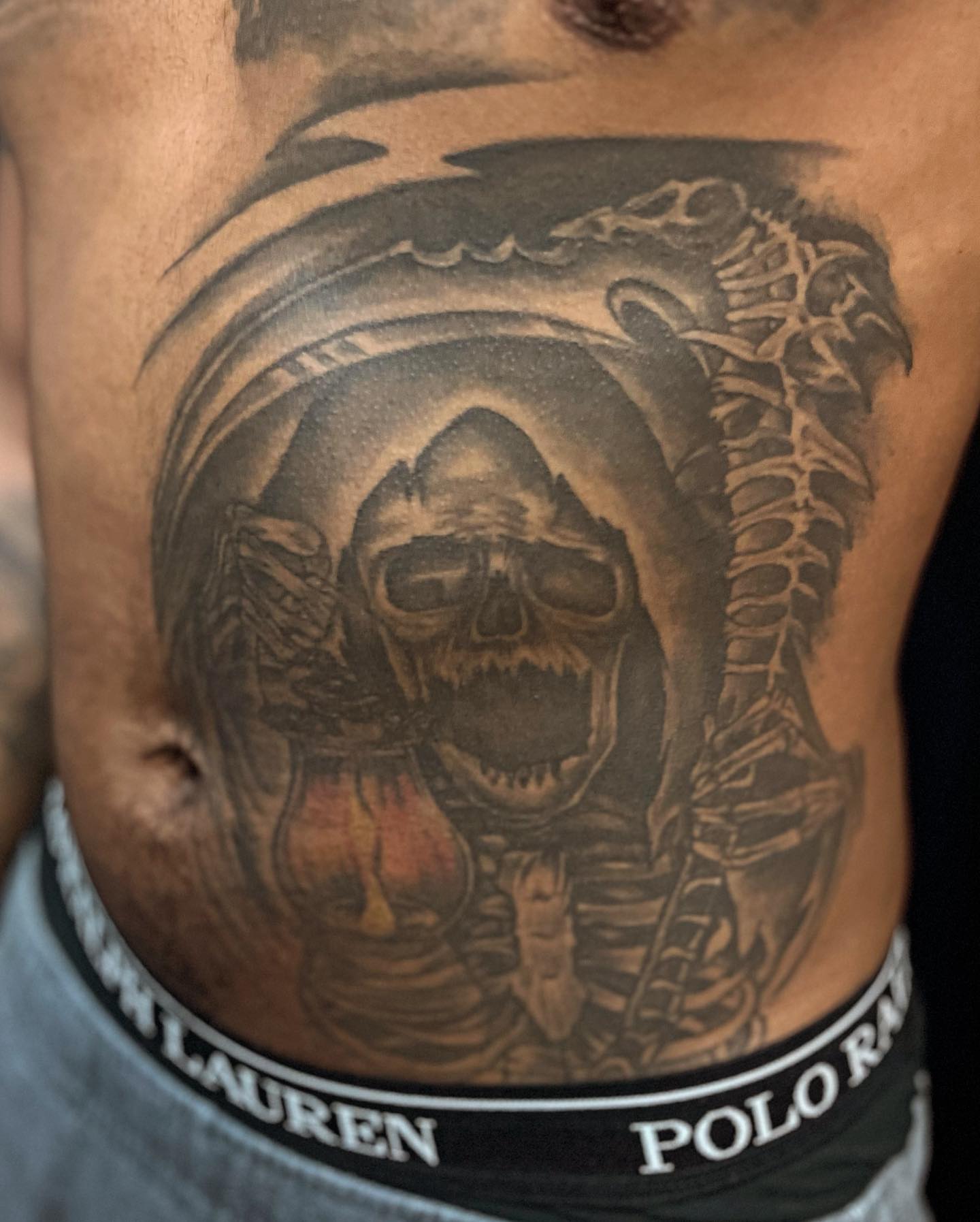 Grim reaper realism tattoo on the ribs by Adrian Shan Carr