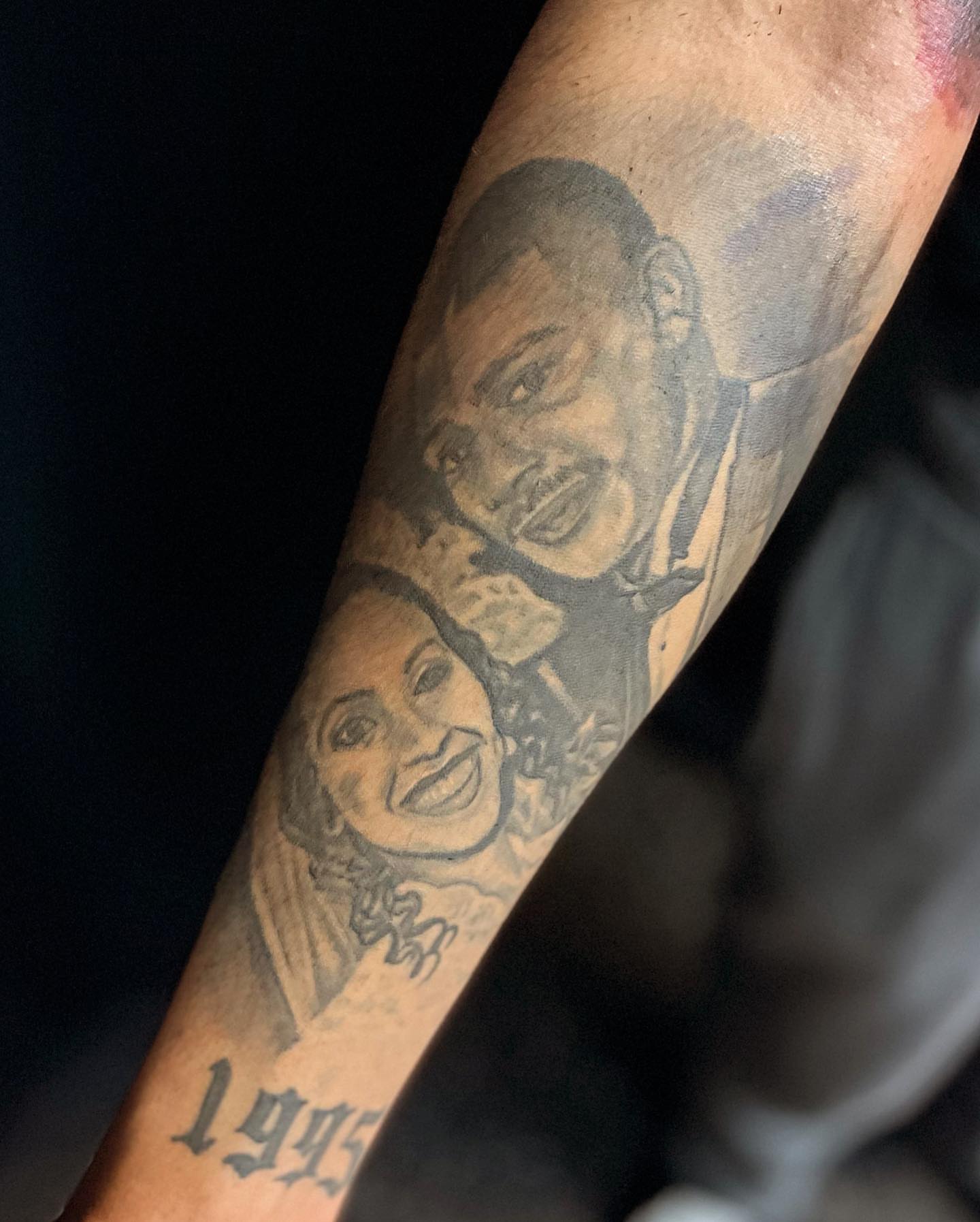 Couple portrait black and grey tattoo on the forearm by Adrian Shan Carr