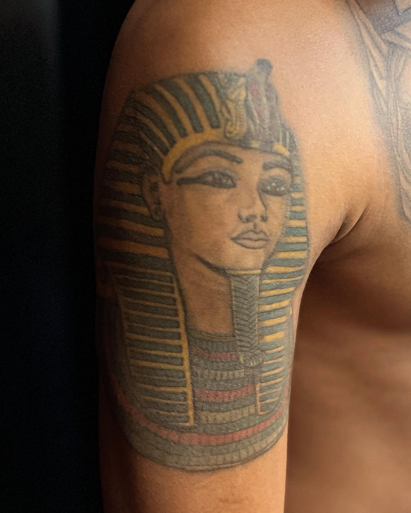 Pharaoh black and grey tattoo on the upper arm by Adrian Shan Carr