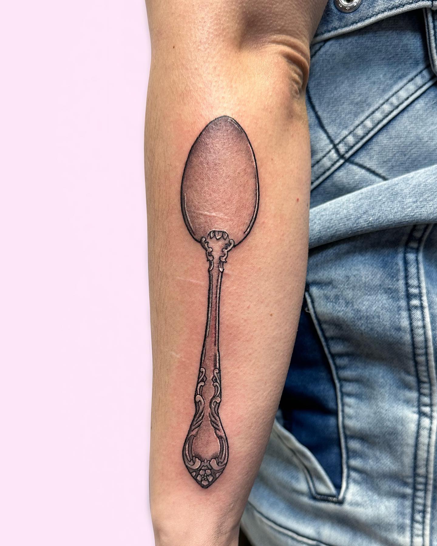 Spoon black and grey tattoo on the forearm by Gabby Tolley🌛