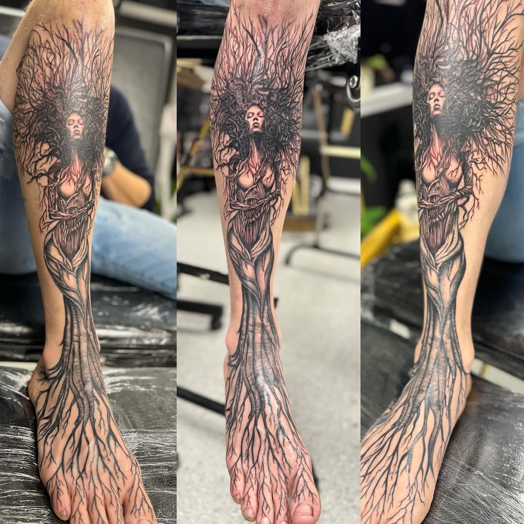 Woman with tree roots dark art tattoo on the calf by Aura Noire