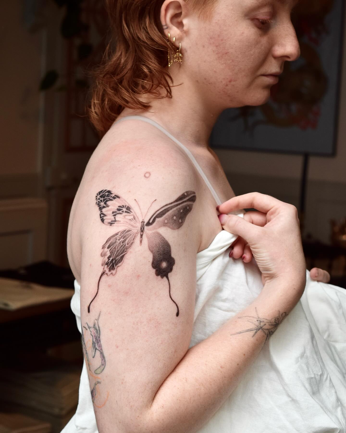 Butterfly black and grey tattoo on the shoulder by Stella Oh