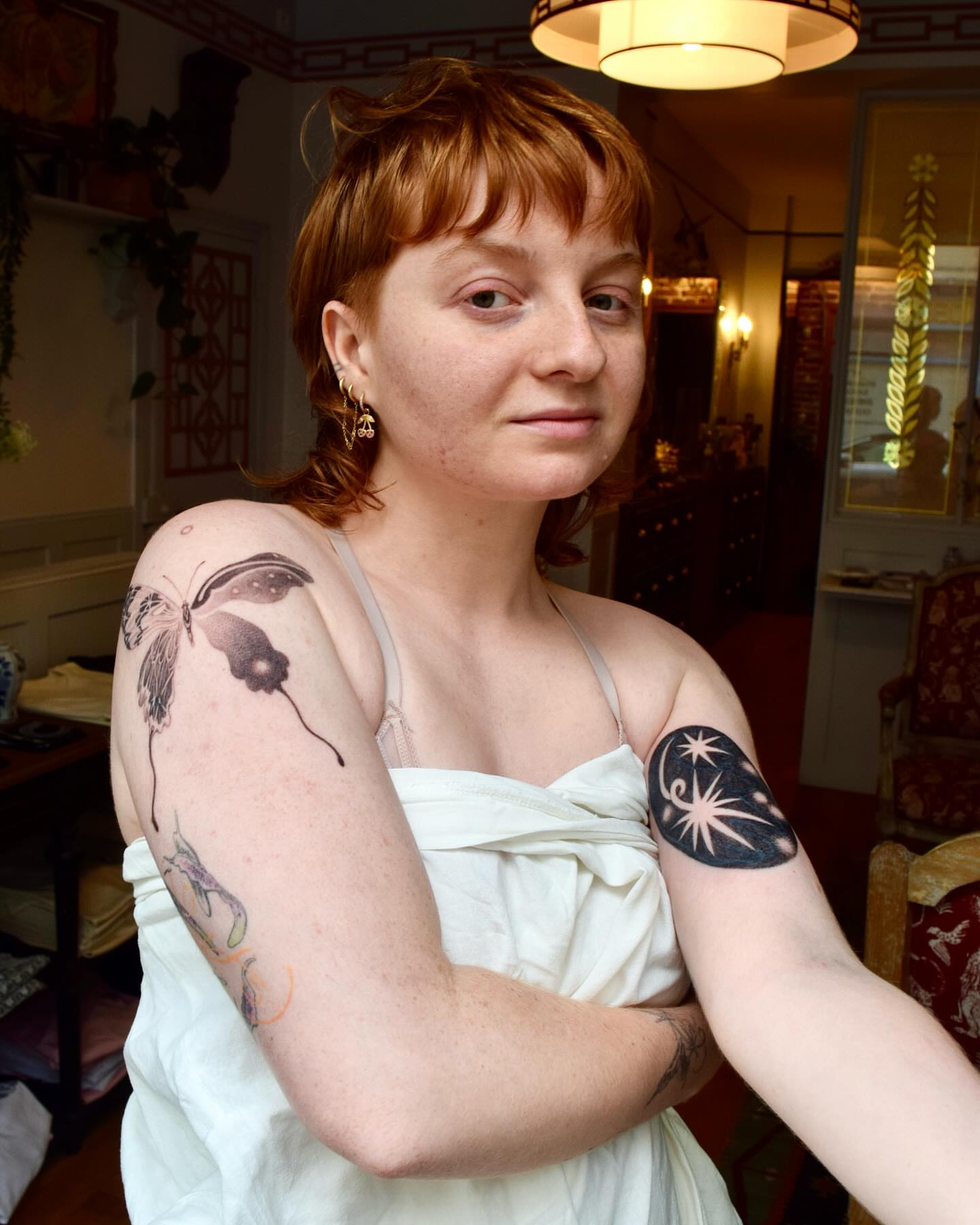 Butterfly black and grey tattoo on the upper arm by Stella Oh