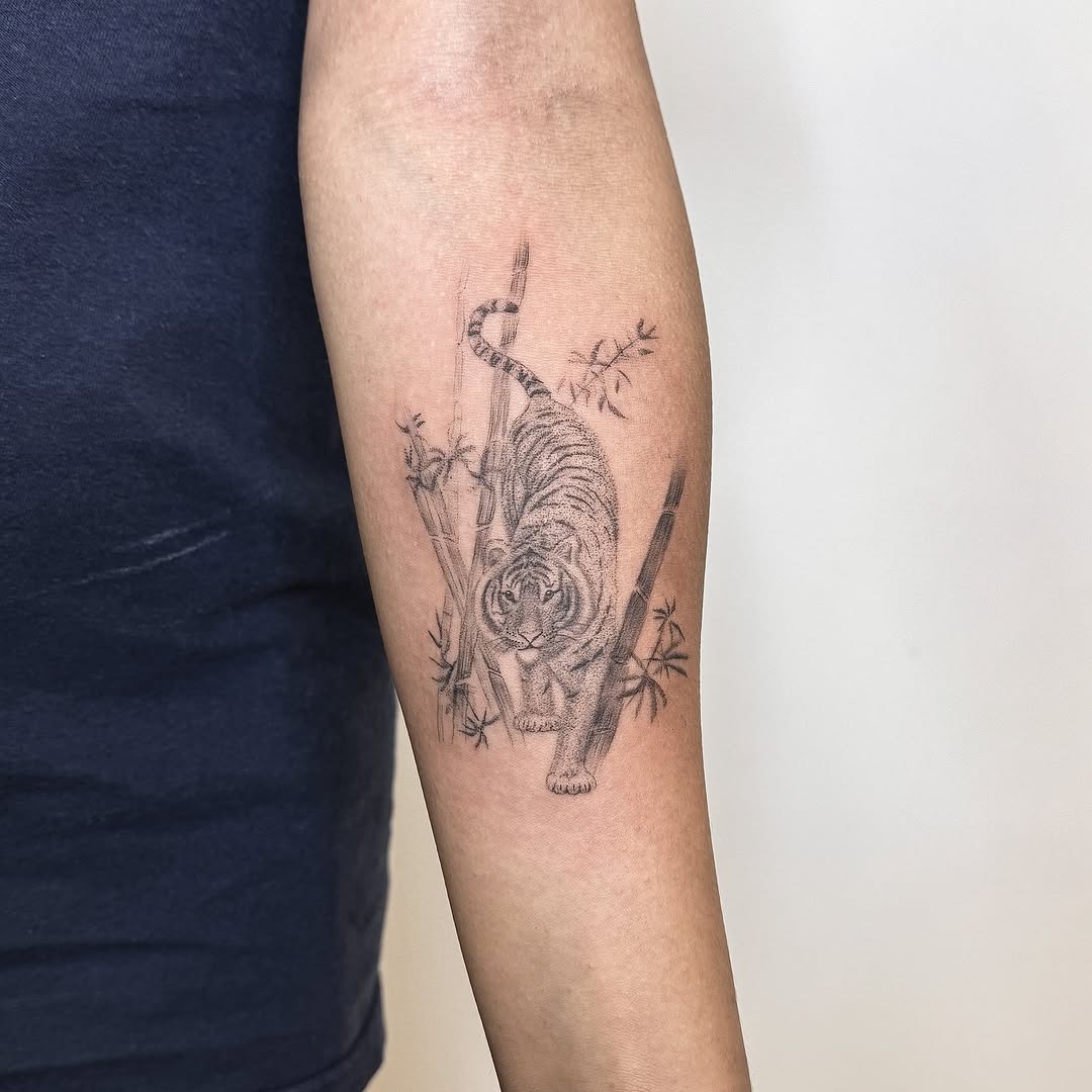Tiger and bamboo realism tattoo on the forearm by INK by CEE