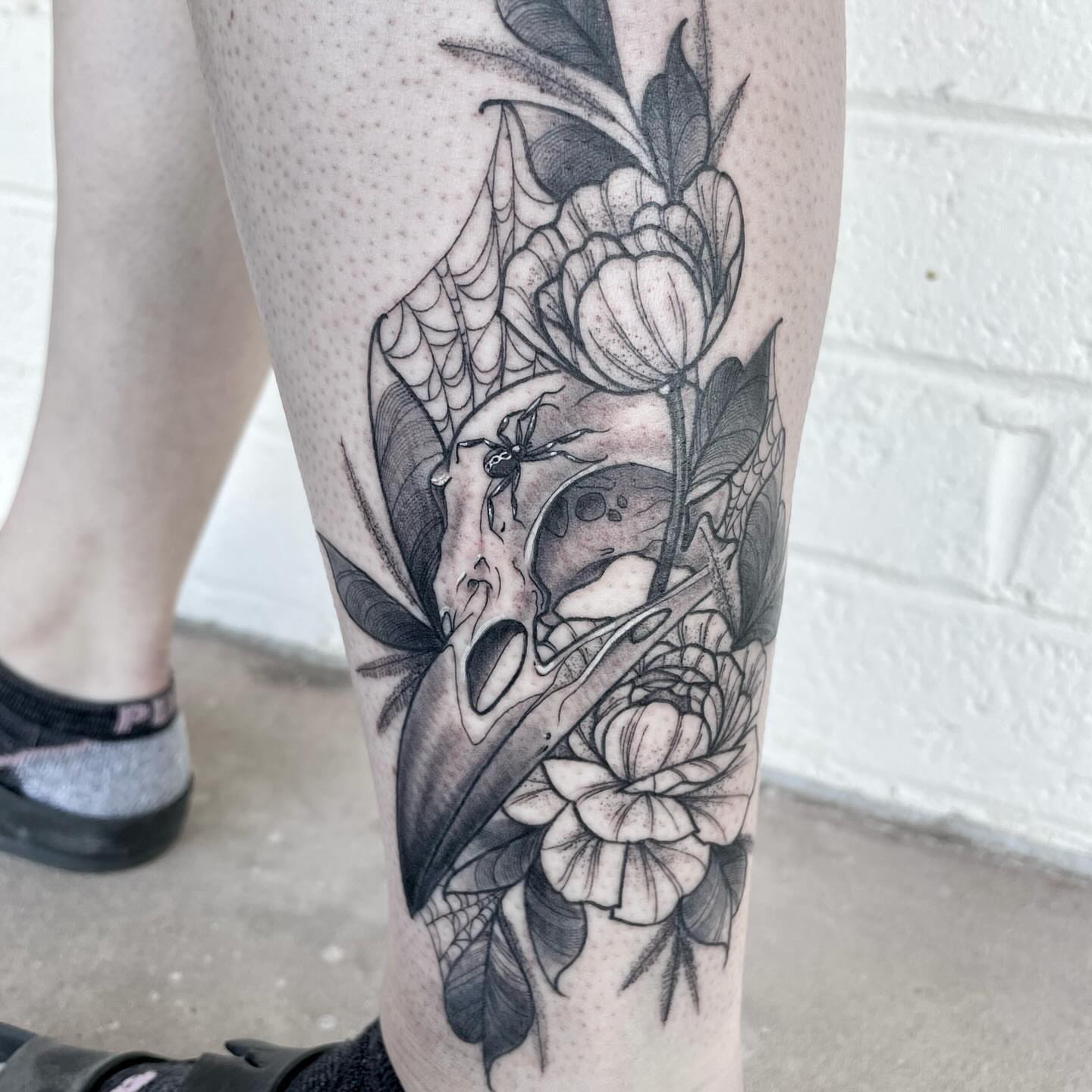 Skull and flowers realism tattoo on the calf by 🌙nadia Renee