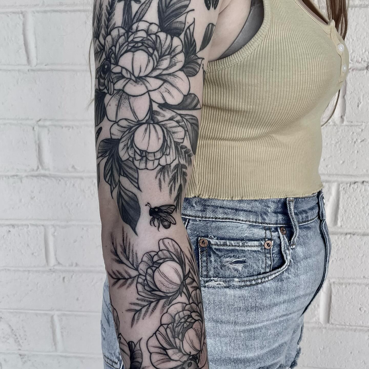 Floral arrangement black and grey tattoo on the forearm by 🌙nadia Renee